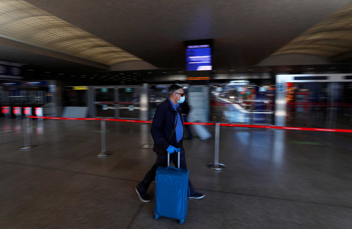 A passenger wearing a protective face mask walks at Rome's Termini train station as Italy relaxes more of its restrictions and allows free movement across the country to unwind its rigid lockdown due to the coronavirus disease (COVID-19) outbreak, in Rome, Italy June 3, 2020. REUTERS