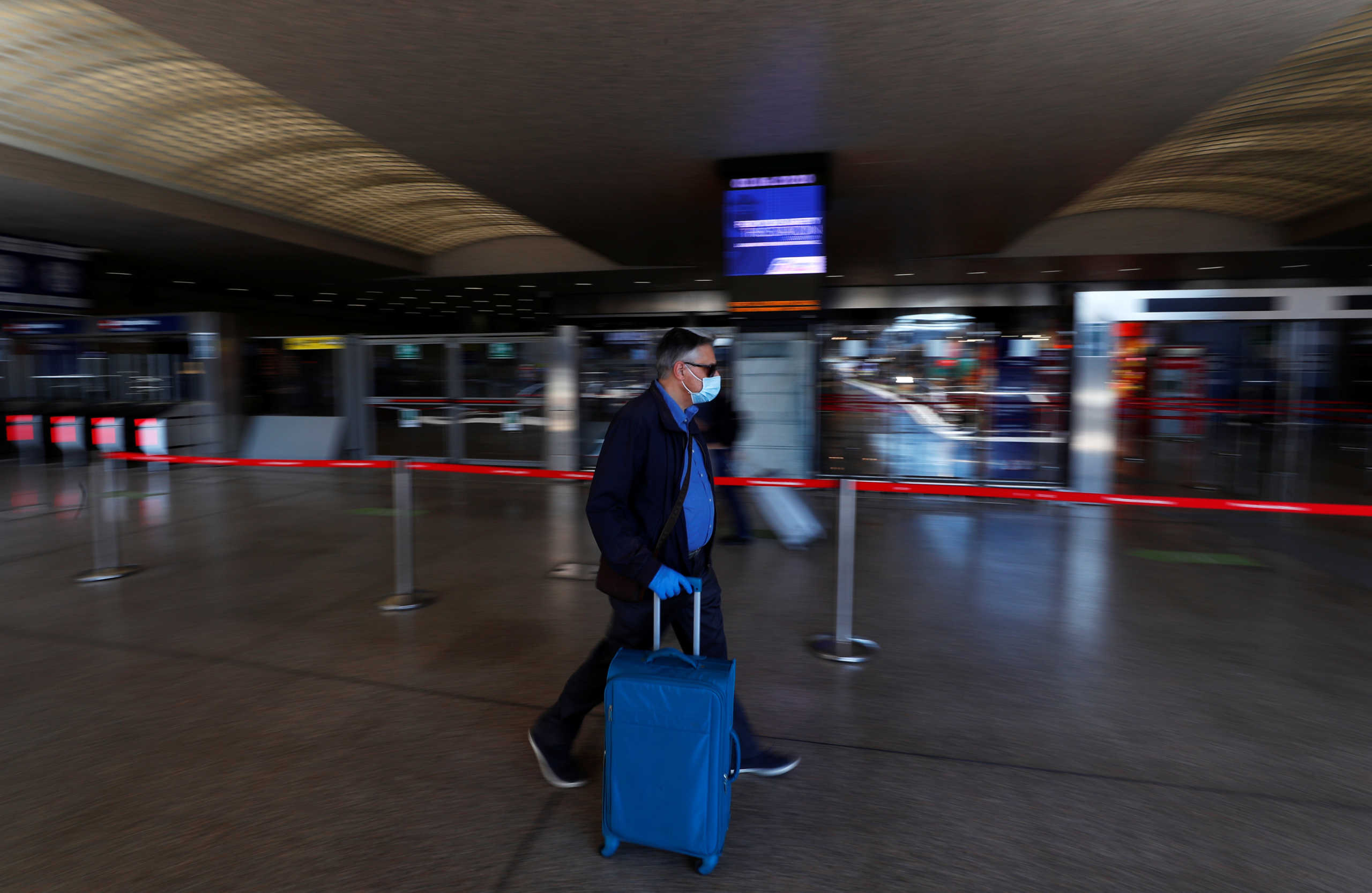 A passenger wearing a protective face mask walks at Rome's Termini train station as Italy relaxes more of its restrictions and allows free movement across the country to unwind its rigid lockdown due to the coronavirus disease (COVID-19) outbreak, in Rome, Italy June 3, 2020. REUTERS