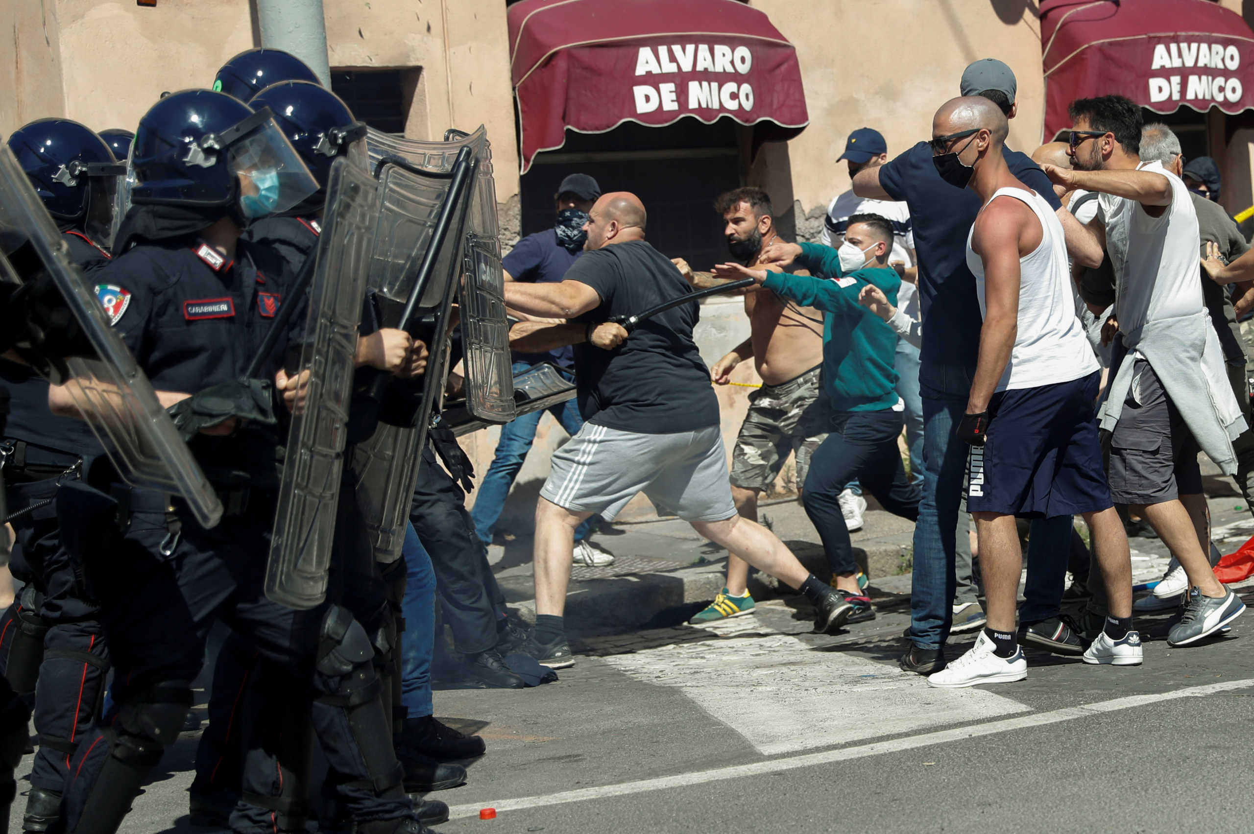 Demonstrators of far-right political movements and hardcore football fans confront police officers as they protest together against the economic crisis caused by the coronavirus disease (COVID-19) outbreak and its handling by the Italian government, in Rome, Italy June 6, 2020. REUTERS