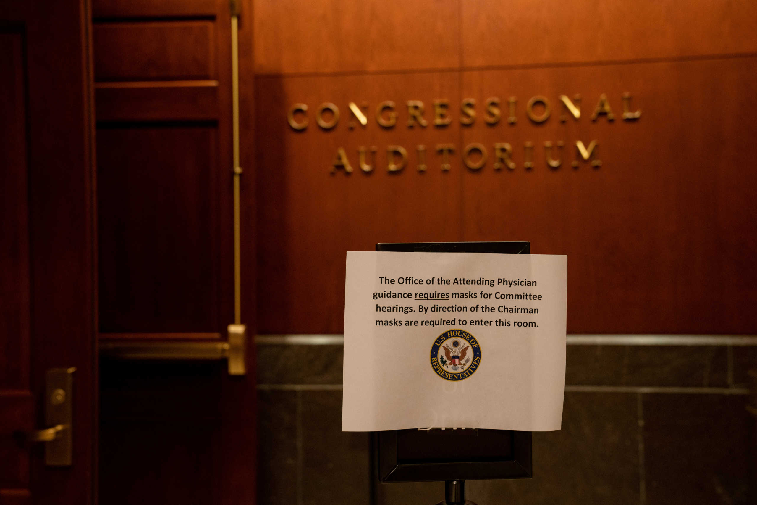 A sign advising members and staffers to wear face masks is pictured outside the room where a hearing of the U.S. House Judiciary Committee about political influence on law enforcement activity, including one who worked on Special Counsel Robert Mueller's Russia probe, is held, in Washington, U.S. June 24, 2020.  Anna Moneymaker
