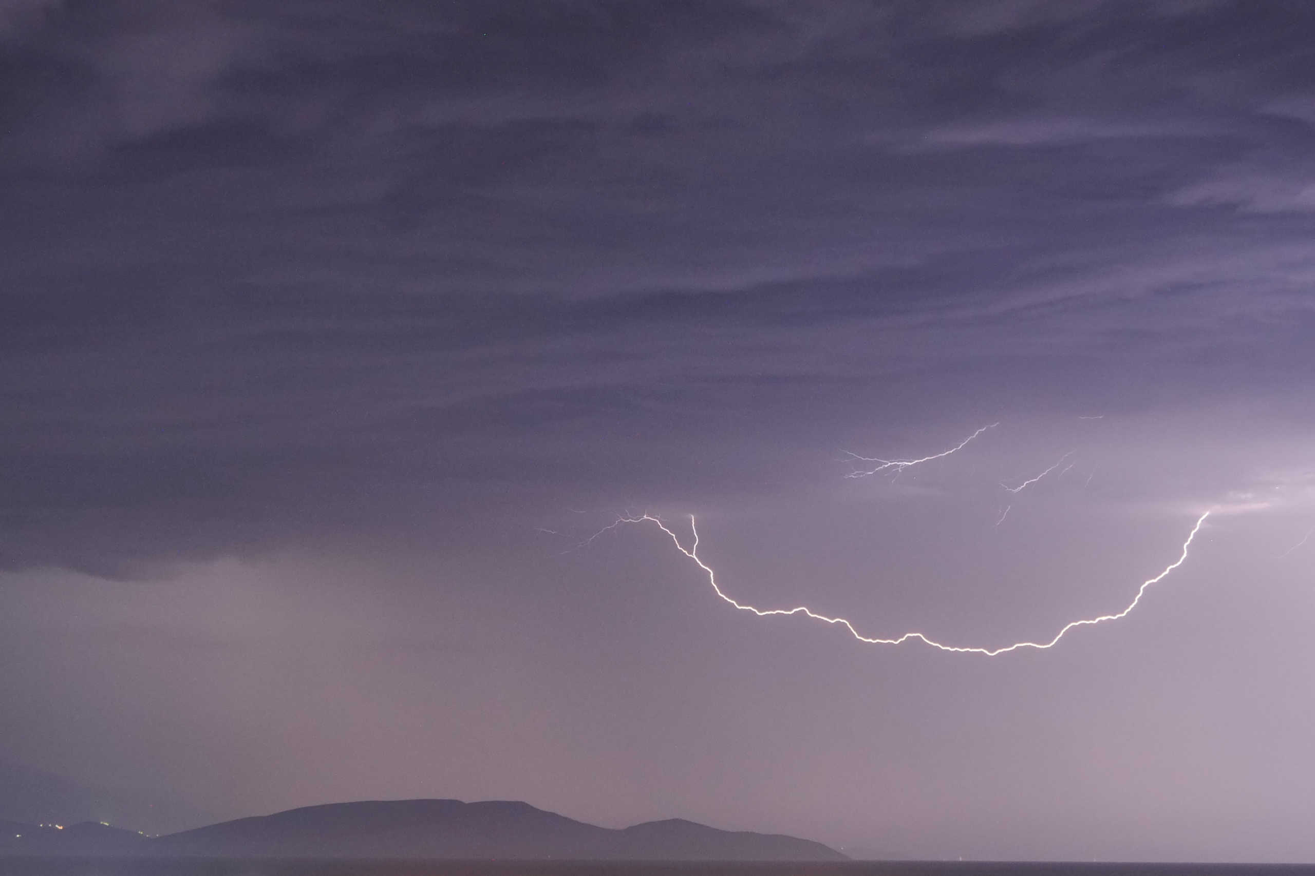 Lightnings strike over the island of Evia as seen from the town of Artemida, Greece, Greece, June 23, 2020. REUTERS