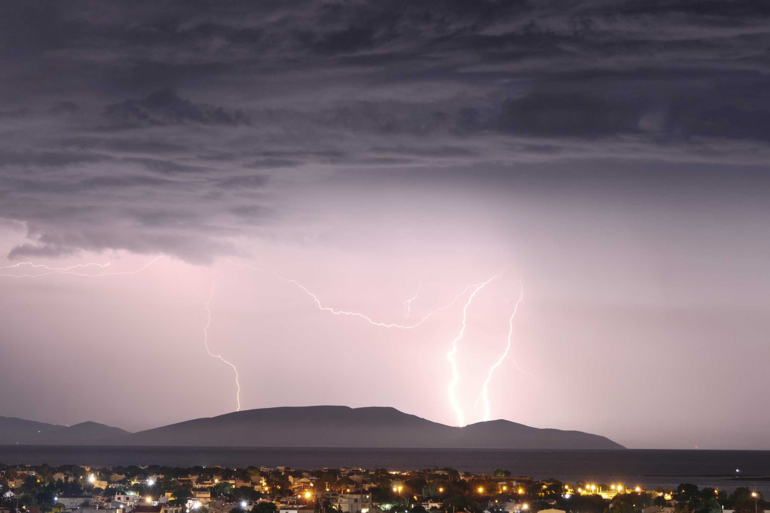 Lightnings strike over the island of Evia as seen from the town of Artemida, Greece, Greece, June 23, 2020. REUTERS
