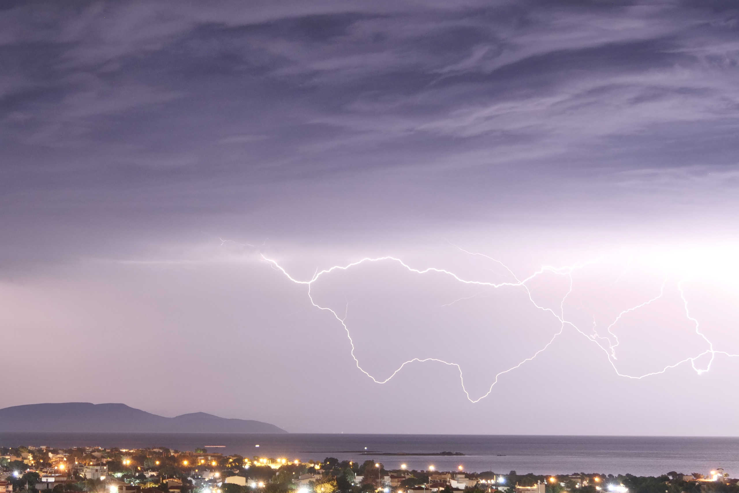 Lightnings strike over the island of Evia as seen from the town of Artemida, Greece, Greece, June 23, 2020. REUTERS