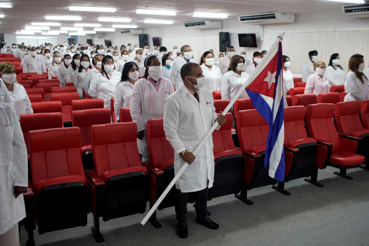 Cuban doctors listen to speeches during a farewell ceremony before departing to Kuwait to assist, amid the coronavirus disease (COVID-19) outbreak, in Havana, Cuba June 4, 2020. REUTERS