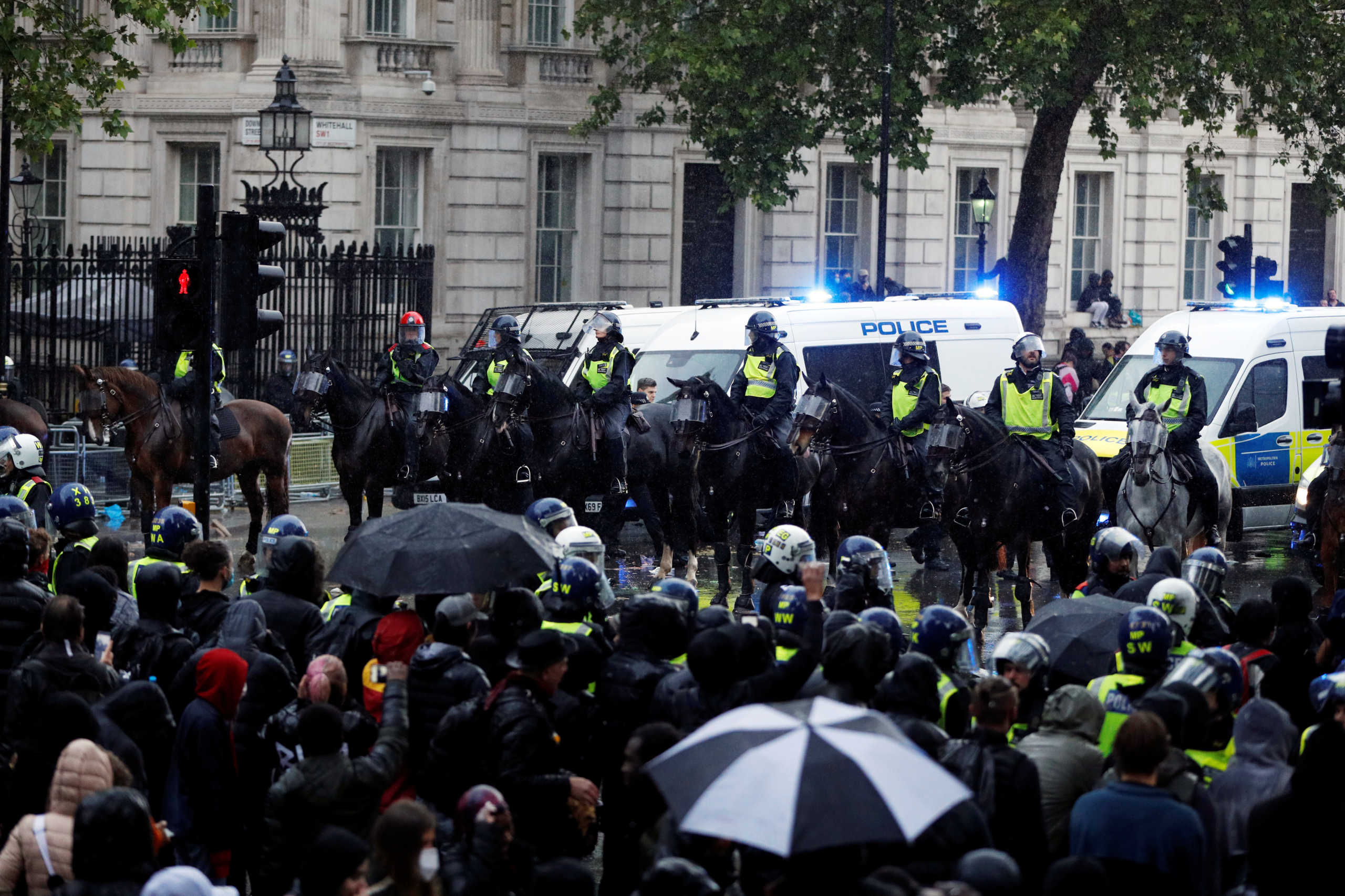 Police officers on horses are seen near demonstrators on Whitehall during a Black Lives Matter protest near Downing street in London, following the death of George Floyd who died in police custody in Minneapolis, London, Britain, June 6, 2020. REUTERS