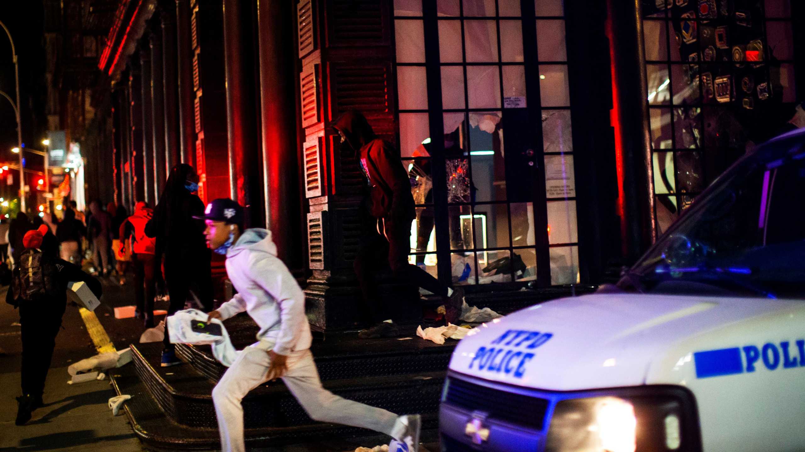 Protesters flee as they loot a store after marching against the death in Minneapolis police custody of George Floyd, in the Manhattan borough of New York City, U.S., June 1, 2020. REUTERS