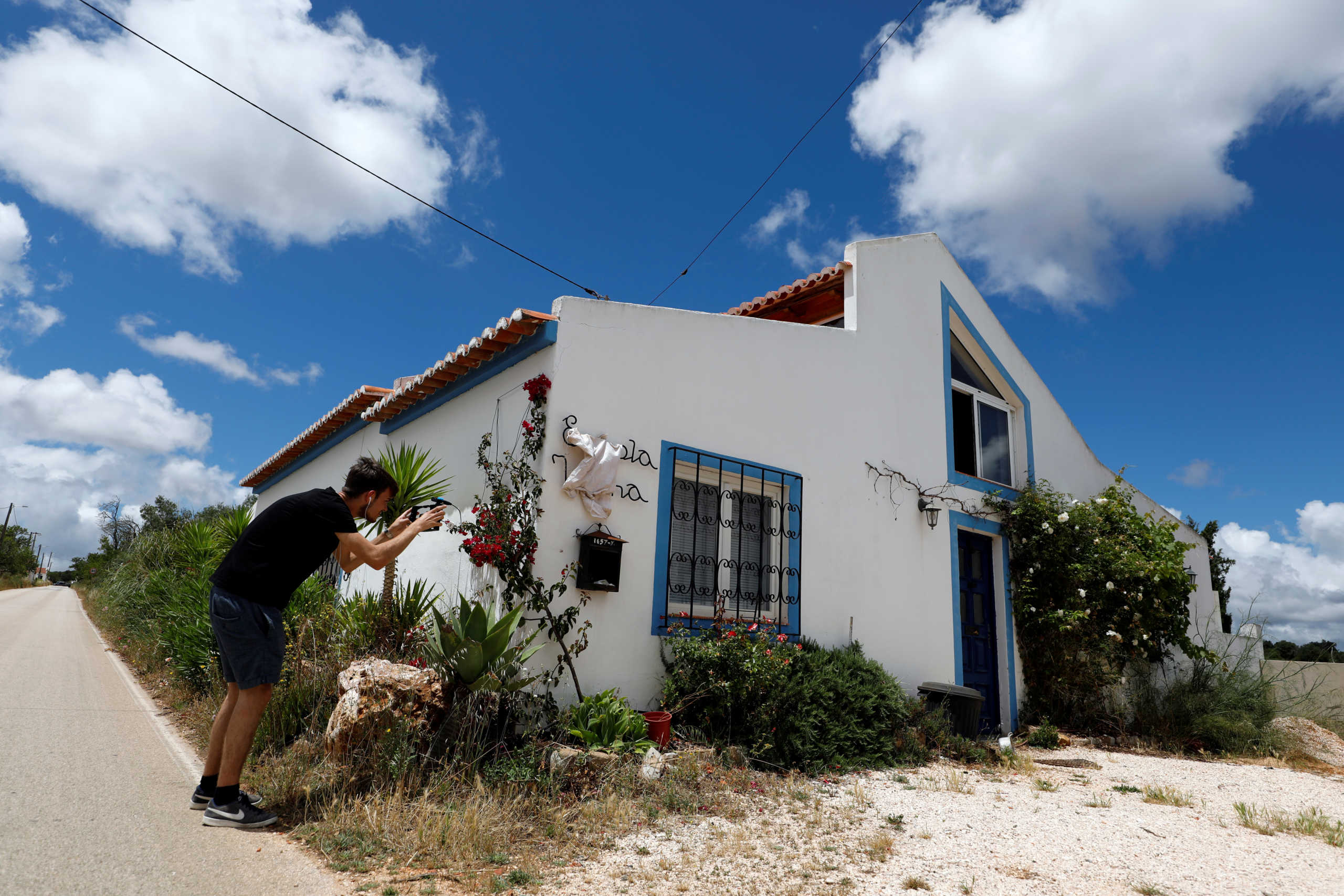 A reporter takes a picture of the house where the suspect lived when three-year-old Madeleine McCann disappeared in 2007, near Lagos, Portugal, June 4, 2020. REUTERS