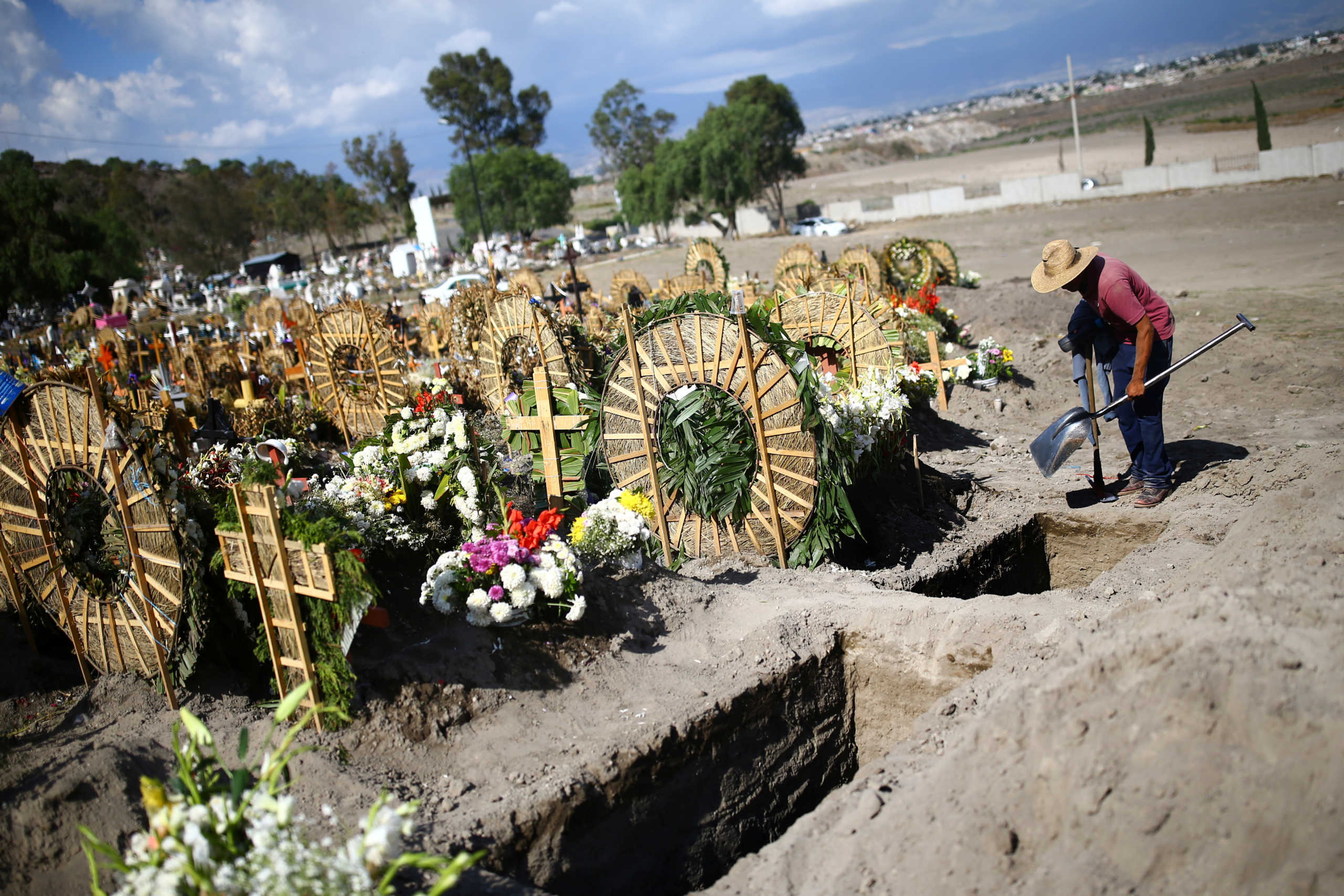 A cemetery worker holds his tools at the Xico cemetery on the outskirts of Mexico City, as the coronavirus disease (COVID-19) outbreak continues in Mexico, June 26, 2020. REUTERS