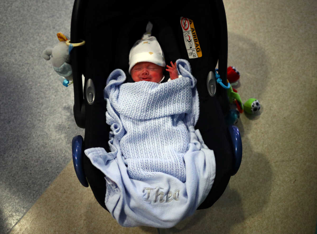 Theo Anderson, who was born prematurely and is now nine weeks old, sleeps in a car seat as his parents prepare to take him home from the Lancashire Women and Newborn Centre of Burnley General Hospital in East Lancashire, following the spread of the coronavirus disease (COVID-19) in Burnley, Britain, June 22, 2020. Picture taken June 22, 2020. REUTERS
