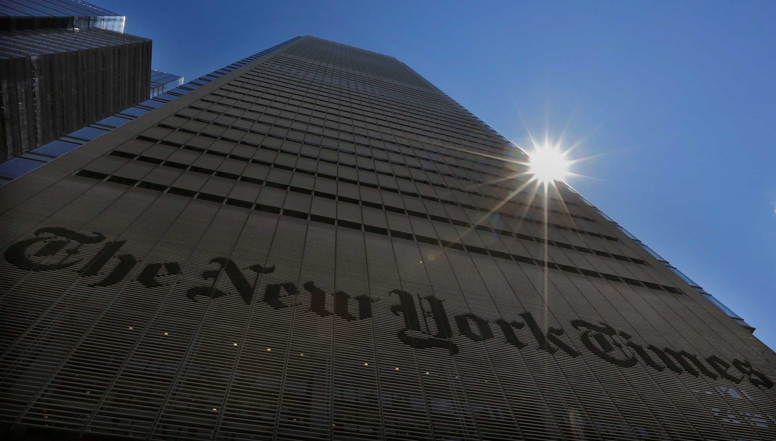 FILE PHOTO: The sun peaks over the New York Times Building in New York August 14, 2013. People accessing nytimes.com earlier on Wednesday saw a message that the service was unavailable. New York Times Co spokeswoman Eileen Murphy said the company thinks the cause of the outage was related to a scheduled maintenance update, which occurred within seconds of the website going down. REUTERS