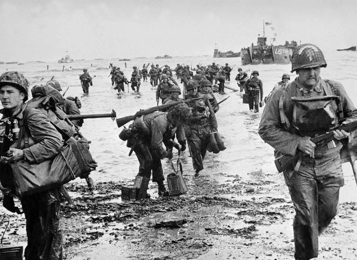 FRANCE - JUNE 06:  American soldiers, their feet in water, are landing on a Normandy beach. In the background are the American military ships which transported them.  (Photo by Keystone-France