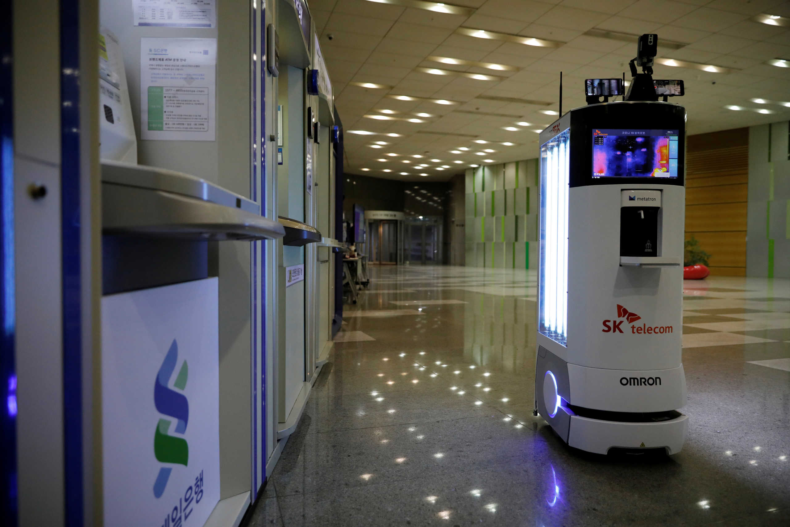 A self-driving robot sanitizes automated teller machines with UV light during its demonstration at the headquarters of SK Telecom in Seoul, South Korea, May 26, 2020. Picture taken on May 26, 2020.   REUTERS