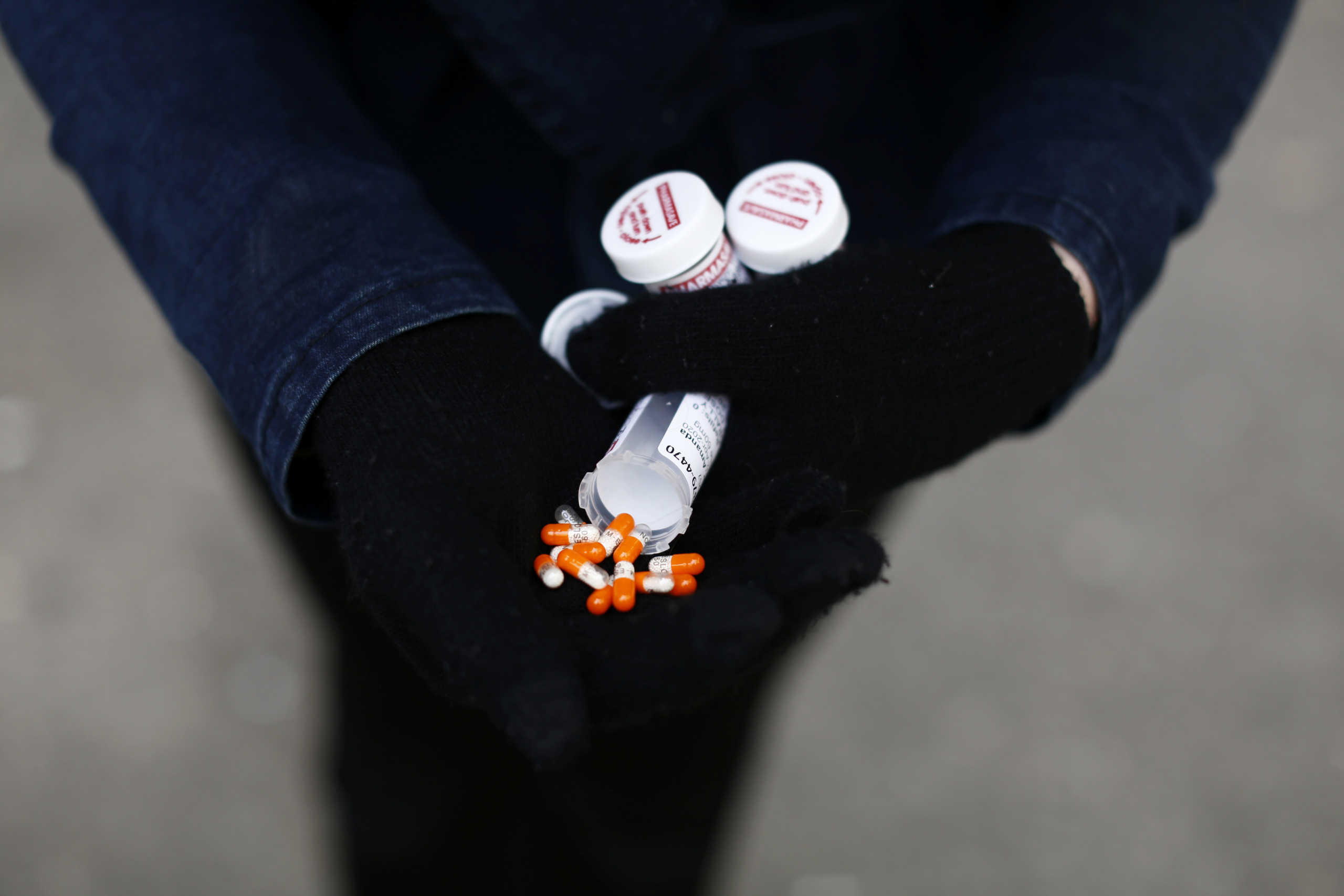 A fentanyl user displays a "safe supply" of opioid alternatives, including morphine pills, provided by the local health unit to combat overdoses due to poisonous additives and to support addicts and the homeless into practicing social distancing to help slow the spread of coronavirus disease (COVID-19) in the Downtown Eastside of Vancouver, British Columbia, Canada April 6, 2020. Picture taken April 6, 2020. REUTERS