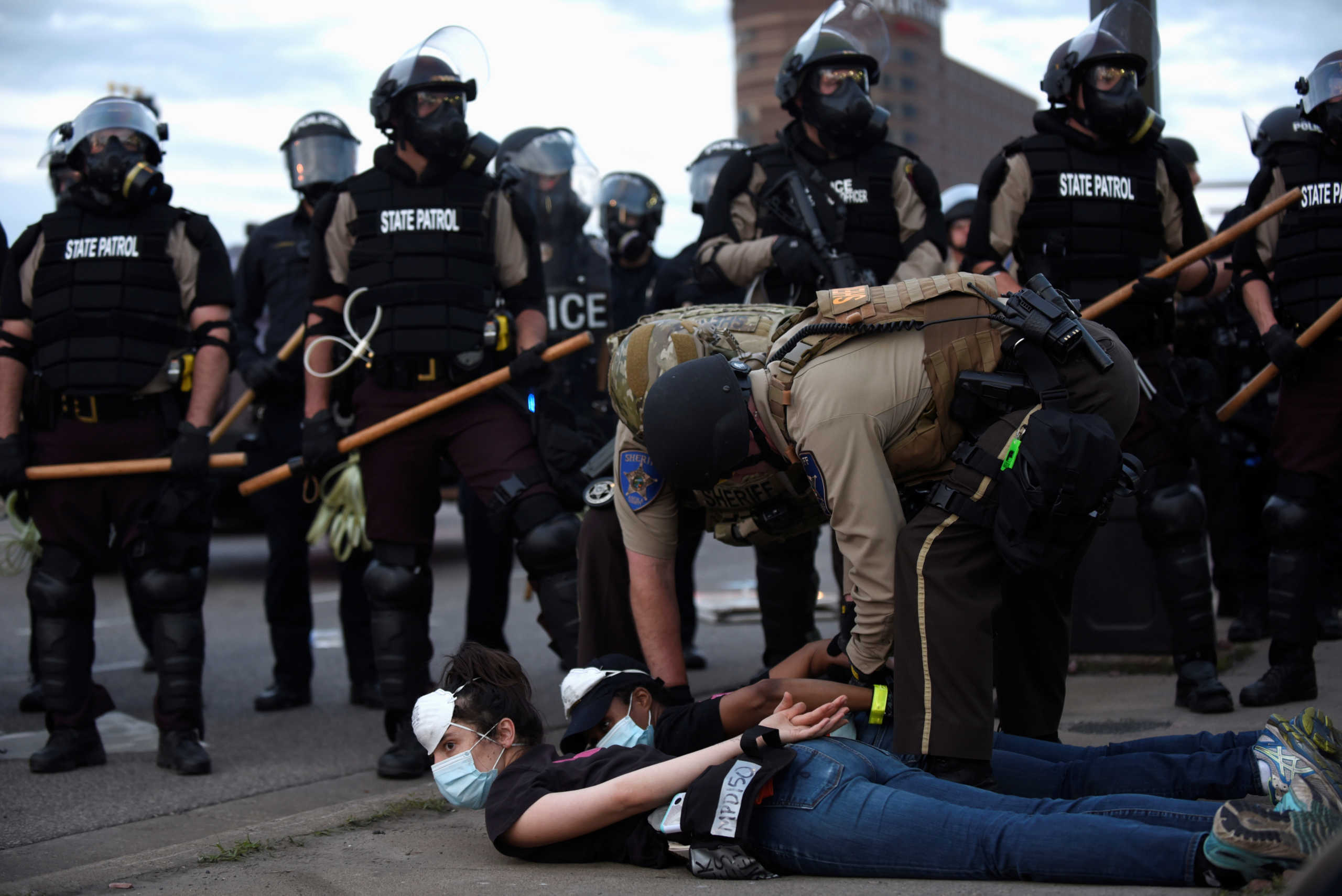 Police detain protesters for violating the curfew during a peaceful demonstration near the Mobil gas station on S Washington Ave by the I-35W on-ramp during the sixth day of demonstrations in response to the death in Minneapolis police custody of George Floyd in Minneapolis, Minnesota, U.S. May 31, 2020. REUTERS
