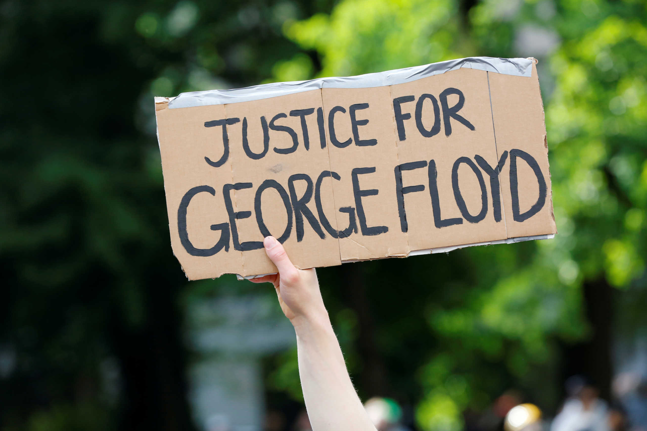 A protester holds a placard during a rally against the death in Minneapolis police custody of George Floyd, in Portland, Oregon, U.S. May 31, 2020. Picture taken May 31, 2020. REUTERS