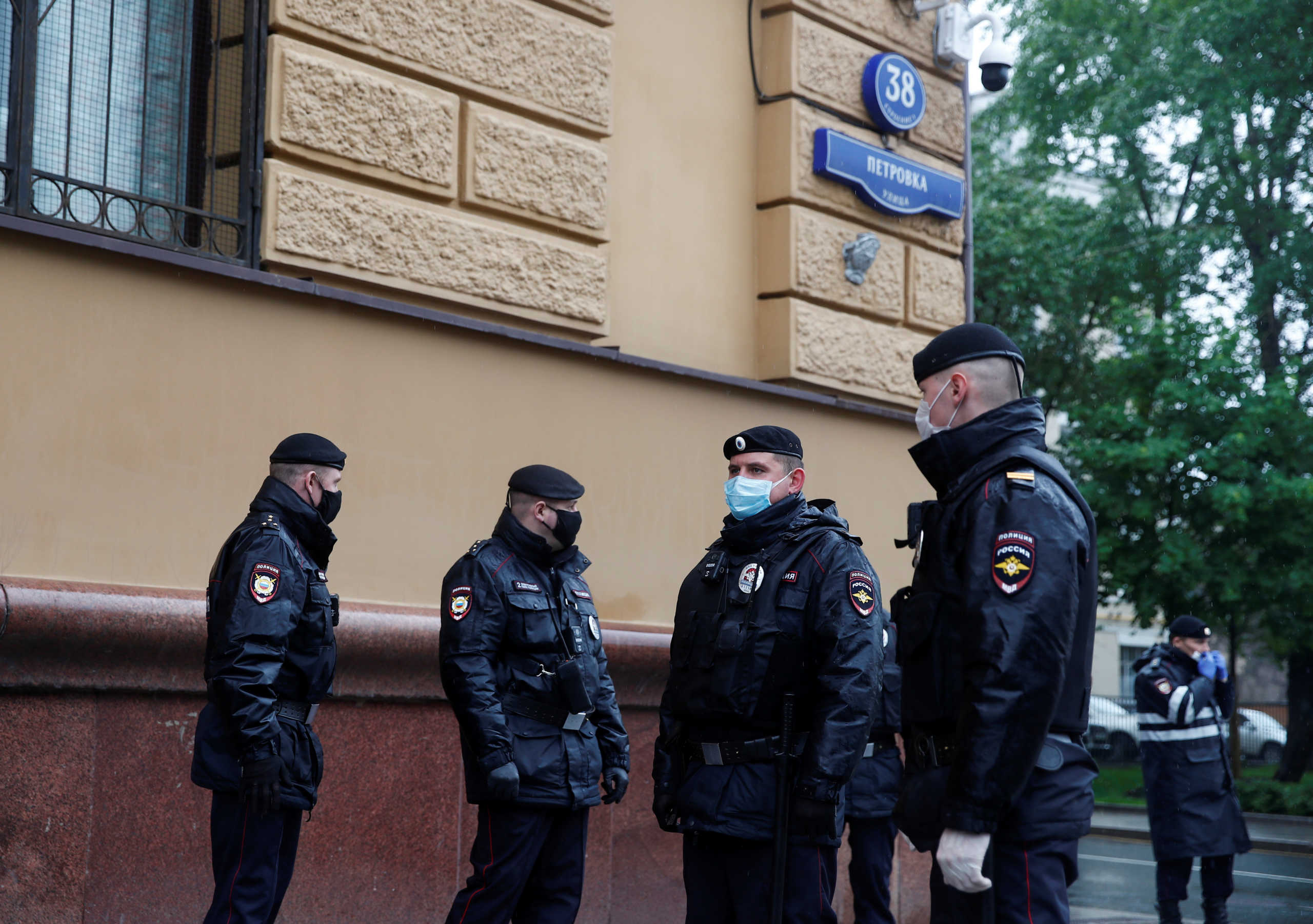 Russian police officers wearing protective face masks stand guard at a venue for pickets in support of journalist Ilya Azar, following a court's decision to jail him for his one-person protest during the coronavirus disease (COVID-19) lockdown, in Moscow, Russia May 29, 2020. REUTERS