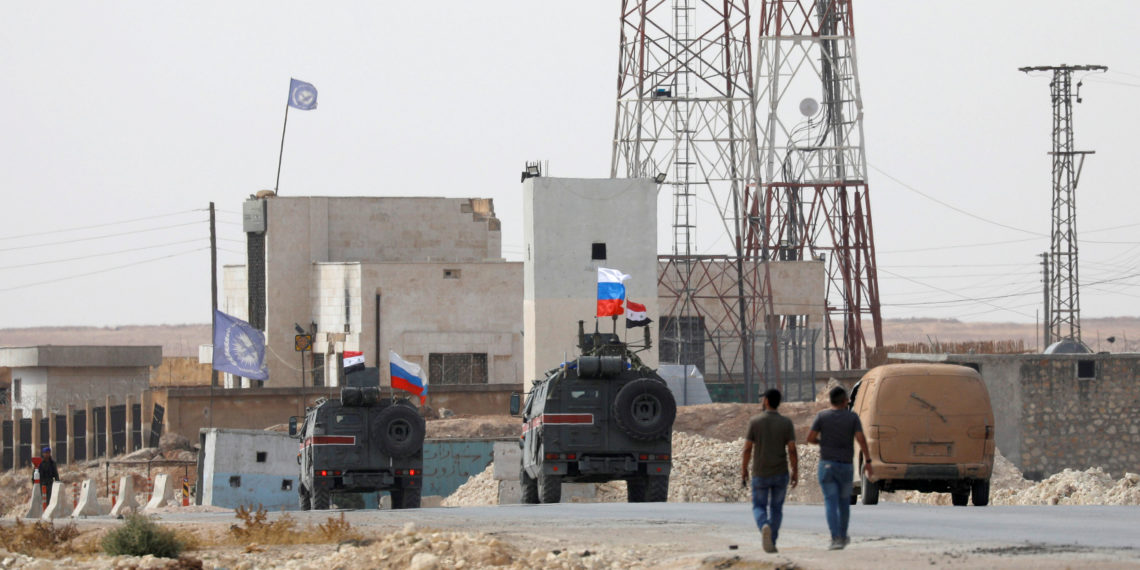 Russian and Syrian national flags flutter on military vehicles near Manbij, Syria October 15, 2019. REUTERS
