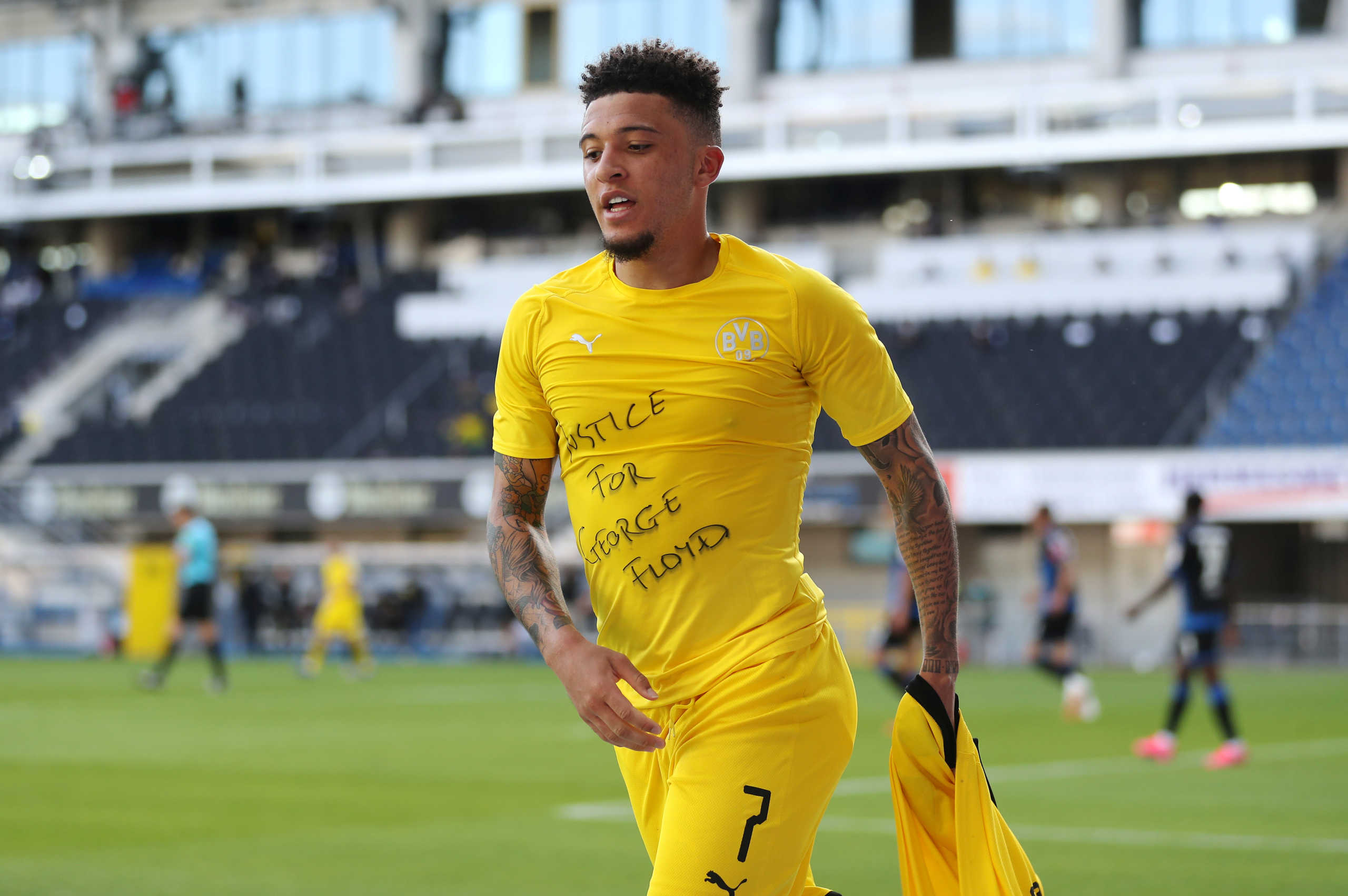 Soccer Football - Bundesliga - SC Paderborn v Borussia Dortmund - Benteler Arena, Paderborn, Germany - May 31, 2020 Borussia Dortmund's Jadon Sancho celebrates scoring their second goal with a 'Justice for George Floyd' shirt, as play resumes behind closed doors following the outbreak of the coronavirus disease (COVID-19) Lars Baron