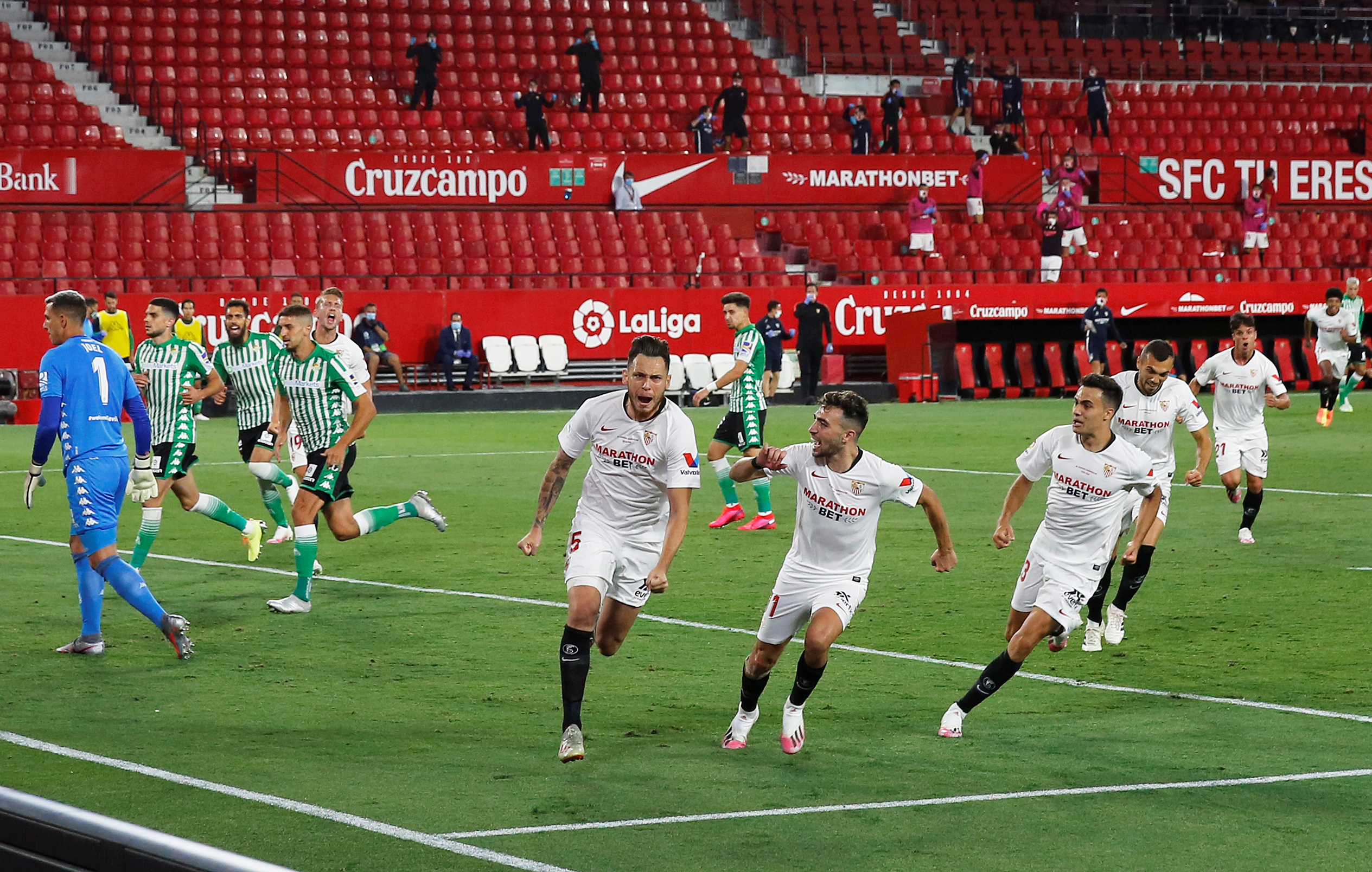 Soccer Football - La Liga Santander - Sevilla v Real Betis - Ramon Sanchez Pizjuan, Seville, Spain - June 11, 2020  Sevilla's Lucas Ocampos celebrates scoring their first goal with teammates as Real Betis players look dejected, as play resumes behind closed doors following the outbreak of the coronavirus disease (COVID-19)   REUTERS