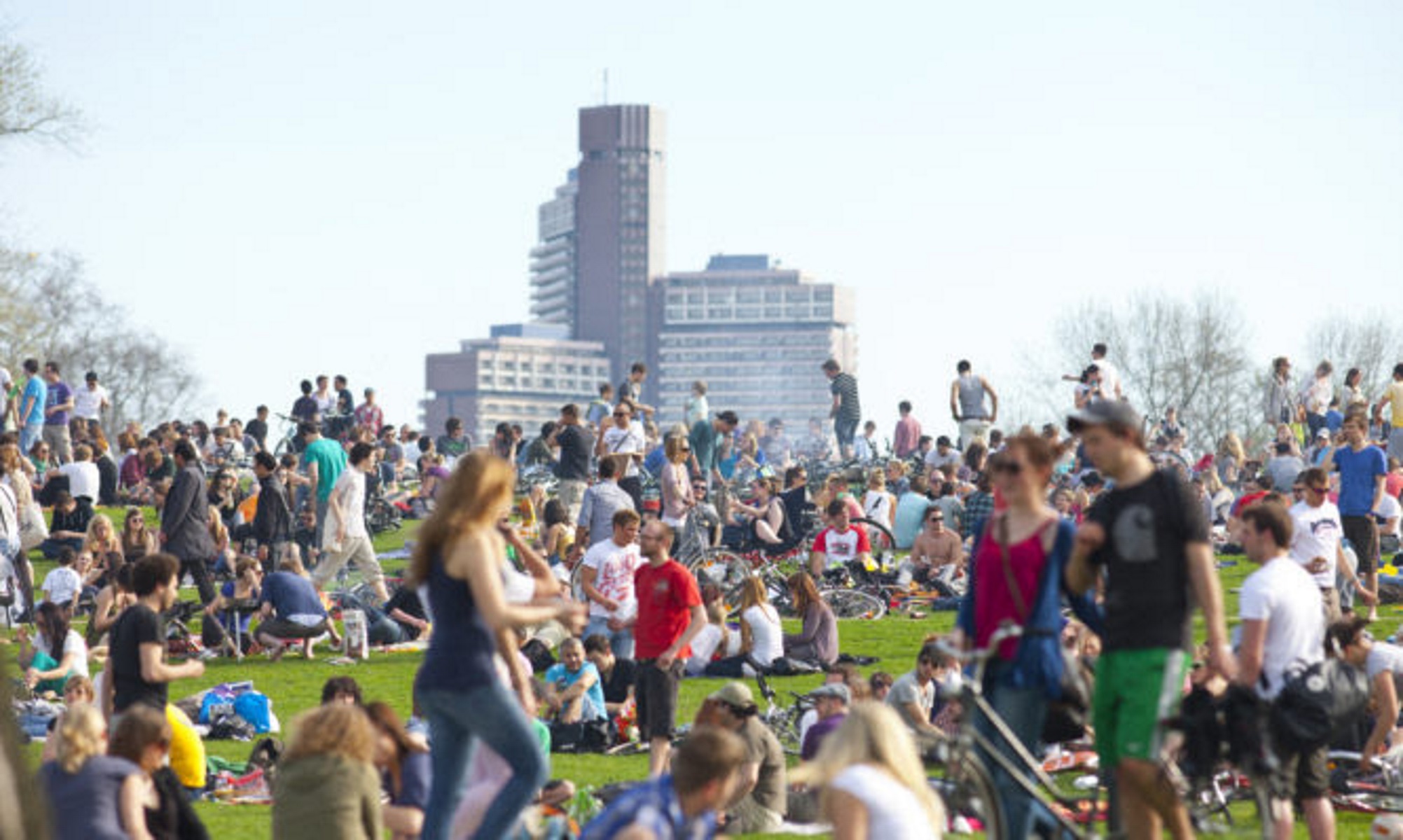 Cologne, Germany - April 2, 2011. The small hill close to the Aachener Weiher in the centre of Cologne is overcrowded with young people from all parts of the world, enjoying the first warm days of the year - unimaginable in times of corona.