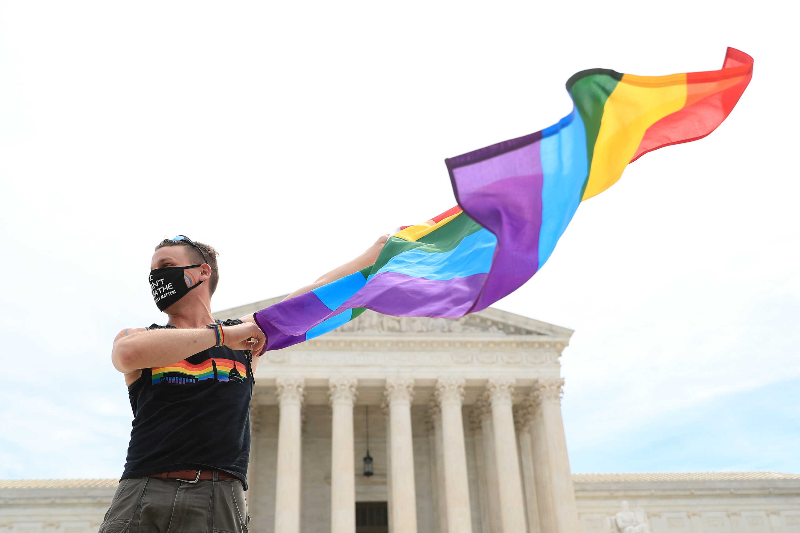 Joseph Fons holding a Pride Flag, stands in front of the U.S. Supreme Court building after the court ruled that a federal law banning workplace discrimination also covers sexual orientation, in Washington, D.C., U.S., June 15, 2020. REUTERS