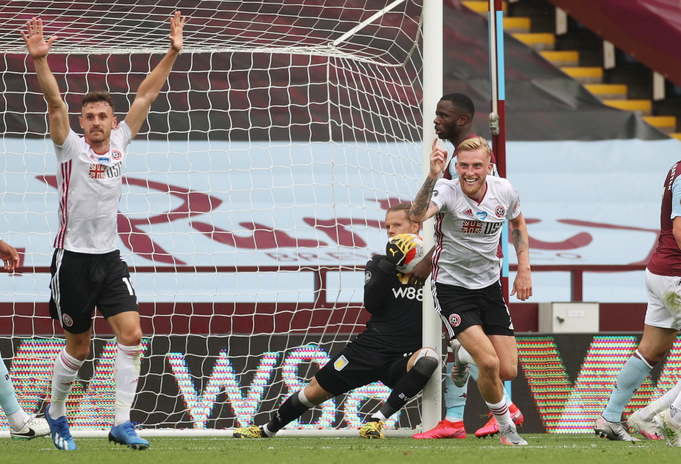Soccer Football - Premier League - Aston Villa v Sheffield United - Villa Park, Birmingham, Britain - June 17, 2020  Sheffield United's Oliver McBurnie celebrates as Aston Villa's Orjan Nyland looks on however a goal is not awarded to Sheffield United as play resumes behind closed doors following the outbreak of the coronavirus disease (COVID-19) REUTERS