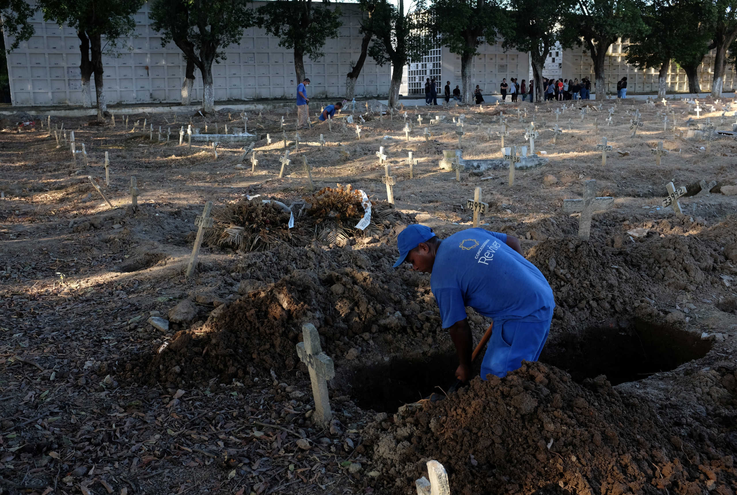Gravediggers work in a burial of a person, who died of unknown reasons during the outbreak of the coronavirus disease (COVID-19), at Sao Francisco Xavier cemetery in Rio de Janeiro. Brazil, April 6, 2020. Picture taken April 6, 2020. REUTERS