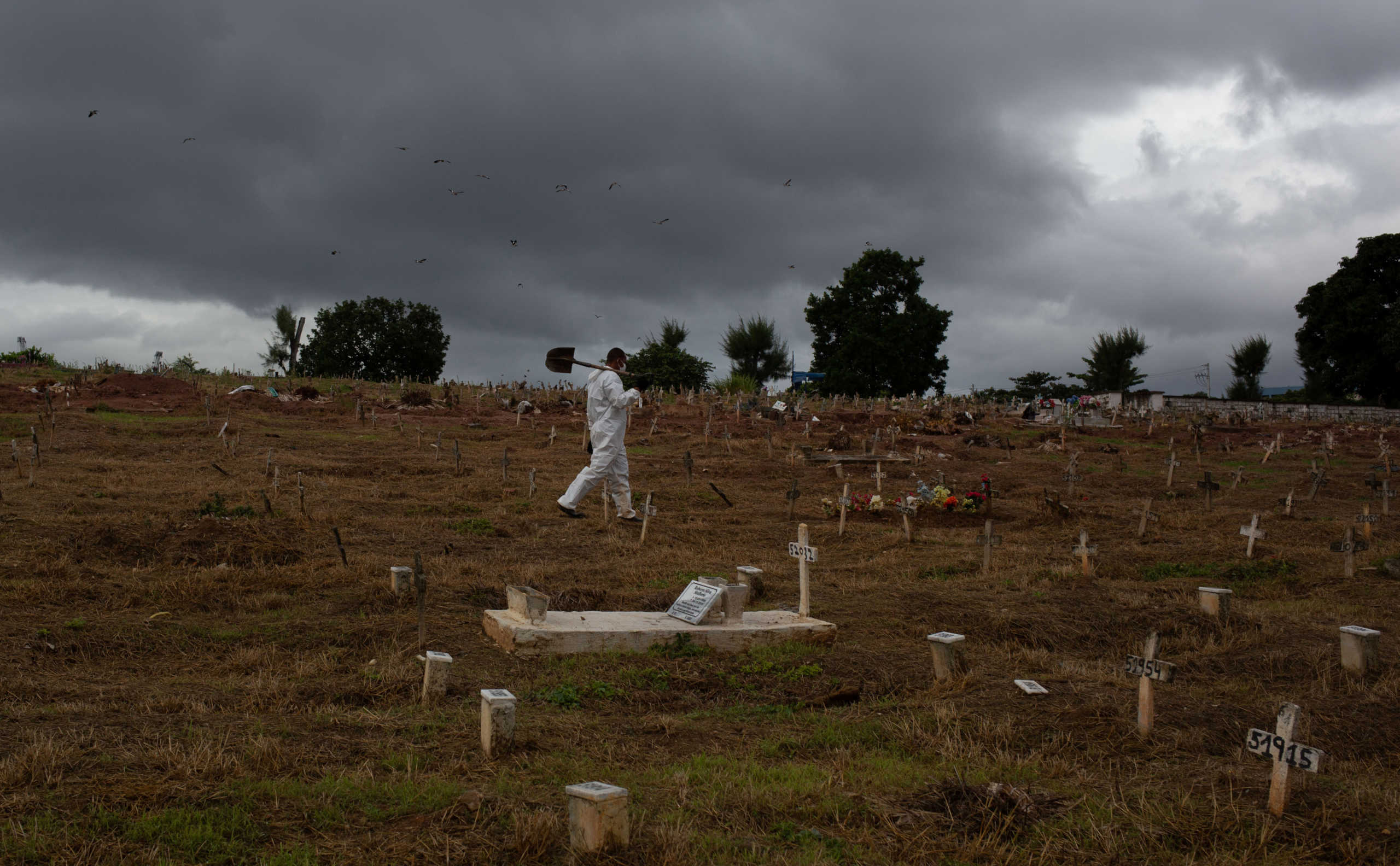A gravedigger walks by Sao Francisco Xavier cemetery during the outbreak of the coronavirus disease (COVID-19), in Rio de Janeiro. Brazil, May 3, 2020. Picture taken May 3, 2020. REUTERS