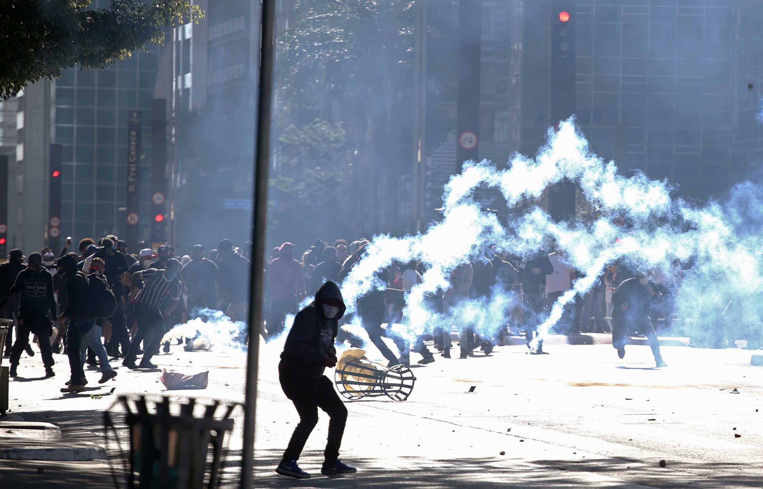 Demonstrators are seen among tear gas during a protest against Brazilian President Jair Bolsonaro at Paulista avenue in Sao Paulo, Brazil, May 31, 2020. REUTERS