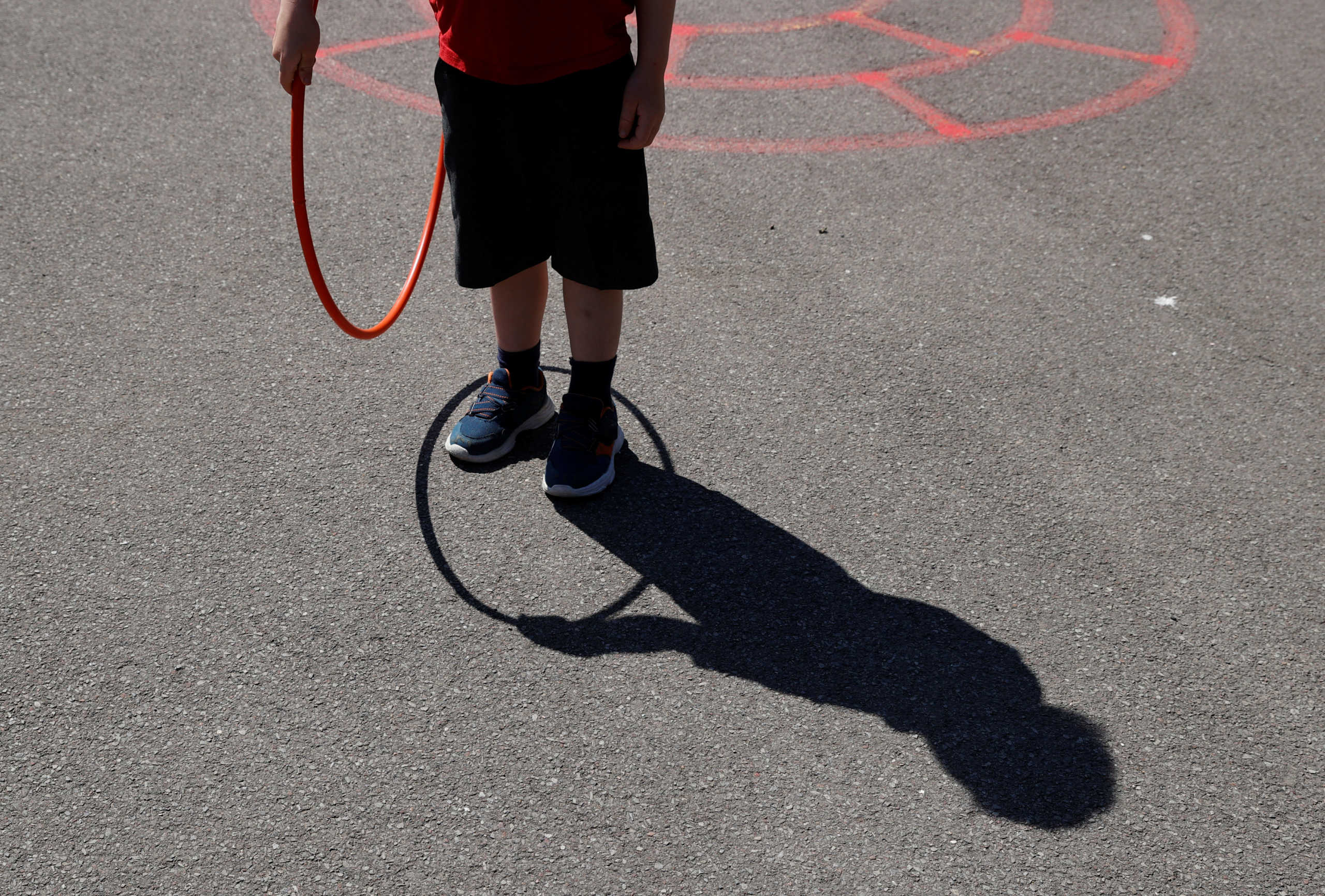A child plays in the playground at Watlington Primary School as some schools re-open, following the outbreak of the coronavirus disease (COVID-19), Watlington, Britain, June 1, 2020. REUTERS