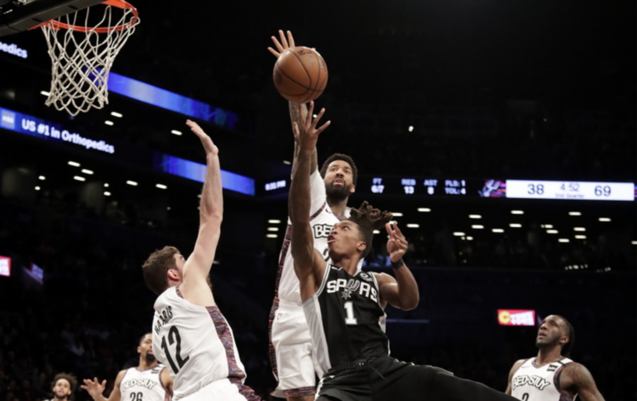 epa08275774 San Antonio Spurs guard Lonnie Walker IV (C) looks to put up a shot past the Brooklyn Nets defense during the NBA basketball game between the San Antonio Spurs and the Brooklyn Nets at Barclays Center in Brooklyn, New York, USA, 06 March 2020.  EPA
