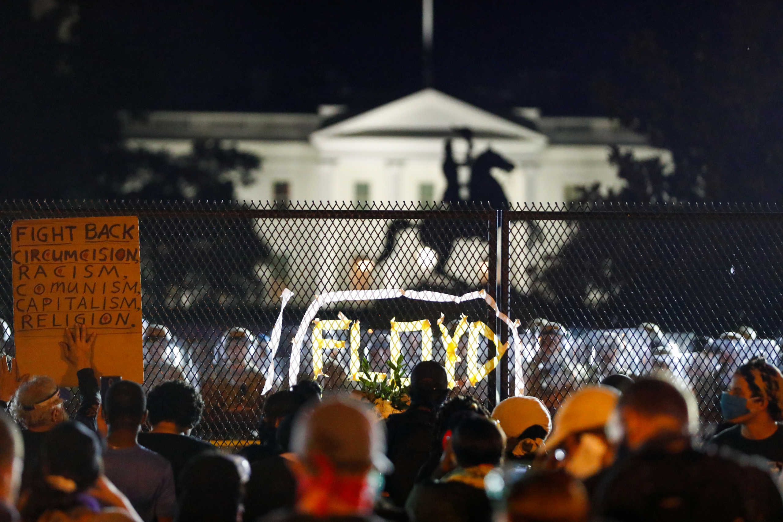 Demonstrators gather along the fence surrounding Lafayette Park outside the White House as protests continue over the death in police custody of George Floyd, in Washington, U.S., June 2, 2020. REUTERS