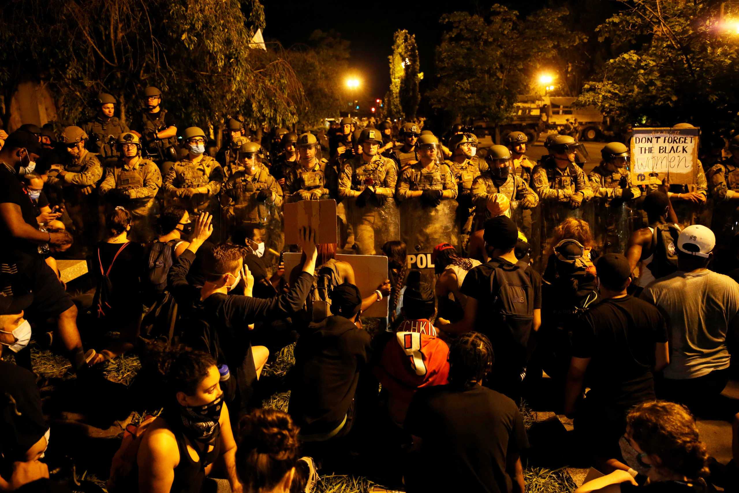 Protesters in front of law enforcement personnel near the White House during rallies against the death in Minneapolis police custody of George Floyd, in Washington, U.S., June 3, 2020. REUTERS