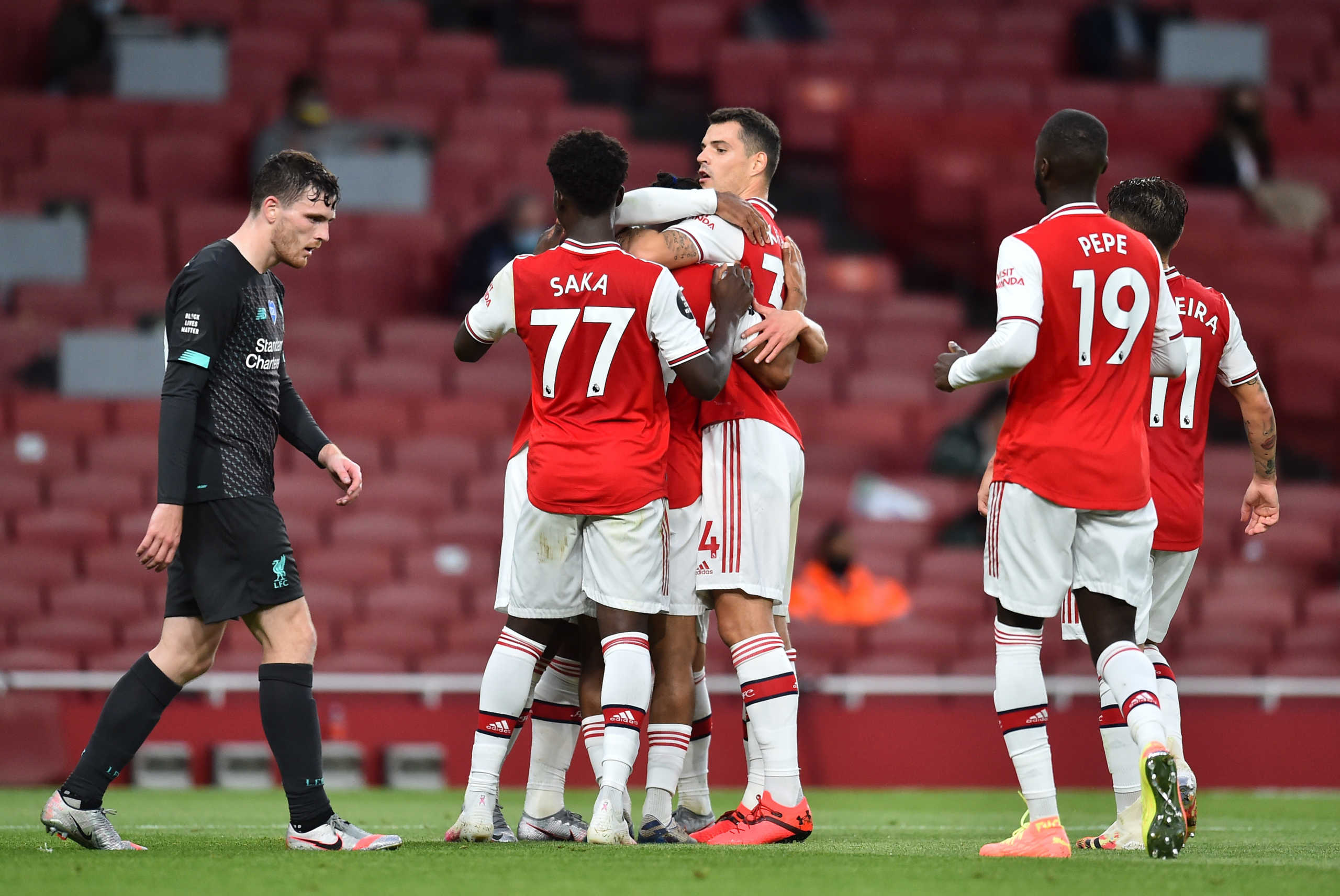 Soccer Football - Premier League - Arsenal v Liverpool - Emirates Stadium, London, Britain - July 15, 2020 Arsenal's Reiss Nelson celebrates scoring their second goal with teammates, as play resumes behind closed doors following the outbreak of the coronavirus disease (COVID-19)  Glyn Kirk