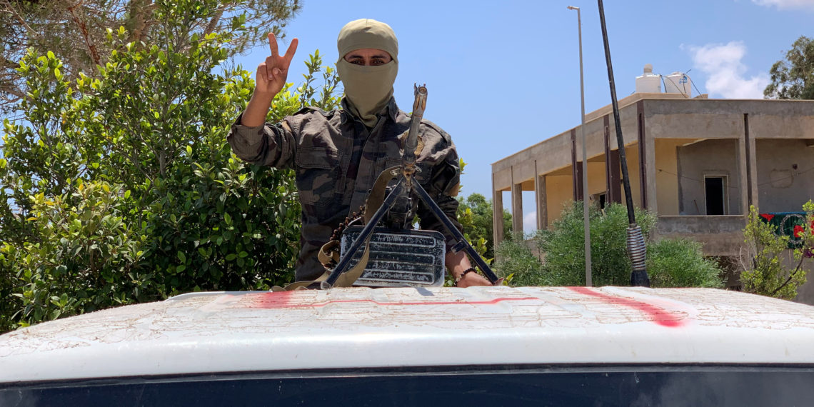 A member of the troops of loyal to Libya's internationally recognized government flashes a victory sign as he prepares himself before heading to Sirte, in Tripoli, Libya, Libya July 6, 2020. REUTERS