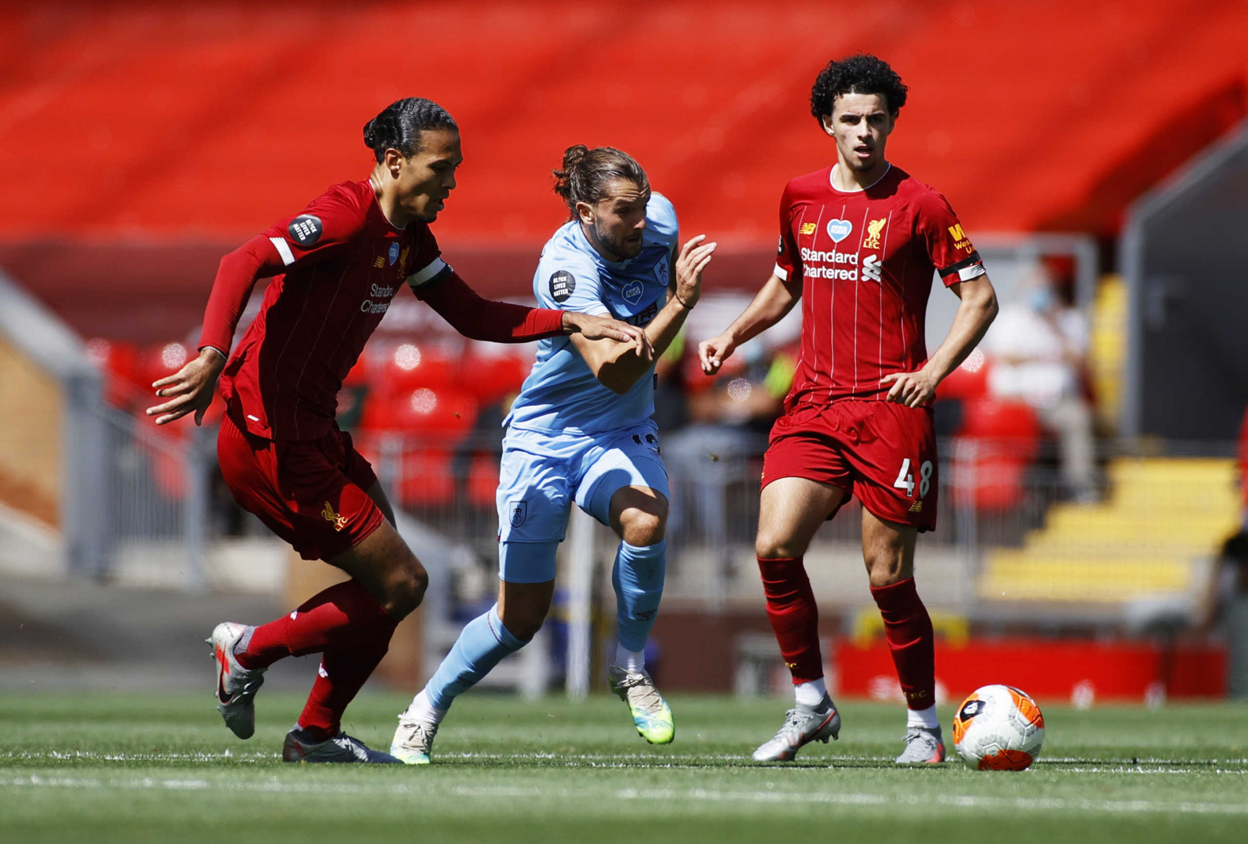 Soccer Football - Premier League - Liverpool v Burnley - Anfield, Liverpool, Britain - July 11, 2020  Burnley's Jay Rodriguez in action with Liverpool's Curtis Jones and Virgil van Dijk, as play resumes behind closed doors following the outbreak of the coronavirus disease (COVID-19) Pool
