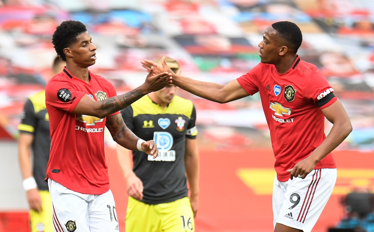 Soccer Football - Premier League - Manchester United v Southampton - Old Trafford, Manchester, Britain - July 13, 2020 Manchester United's Marcus Rashford scores their first goal with Anthony Martial, as play resumes behind closed doors following the outbreak of the coronavirus disease (COVID-19) Pool via REUTERS
