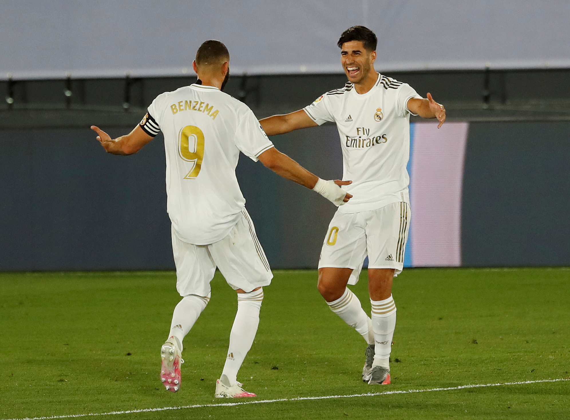Soccer Football - La Liga Santander - Real Madrid v Alaves - Alfredo Di Stefano Stadium, Madrid, Spain - July 10, 2020   Real Madrid's Marco Asensio celebrates scoring their second goal with Karim Benzema, as play resumes behind closed doors following the outbreak of the coronavirus disease (COVID-19)   REUTERS