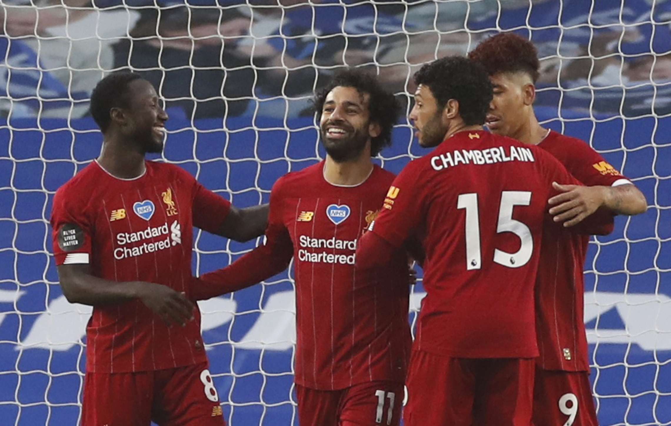 Soccer Football - Premier League - Brighton & Hove Albion v Liverpool - The American Express Community Stadium, Brighton, Britain - July 8, 2020  Liverpool's Mohamed Salah celebrates scoring their first goal with teammates, as play resumes behind closed doors following the outbreak of the coronavirus disease (COVID-19)  REUTERS