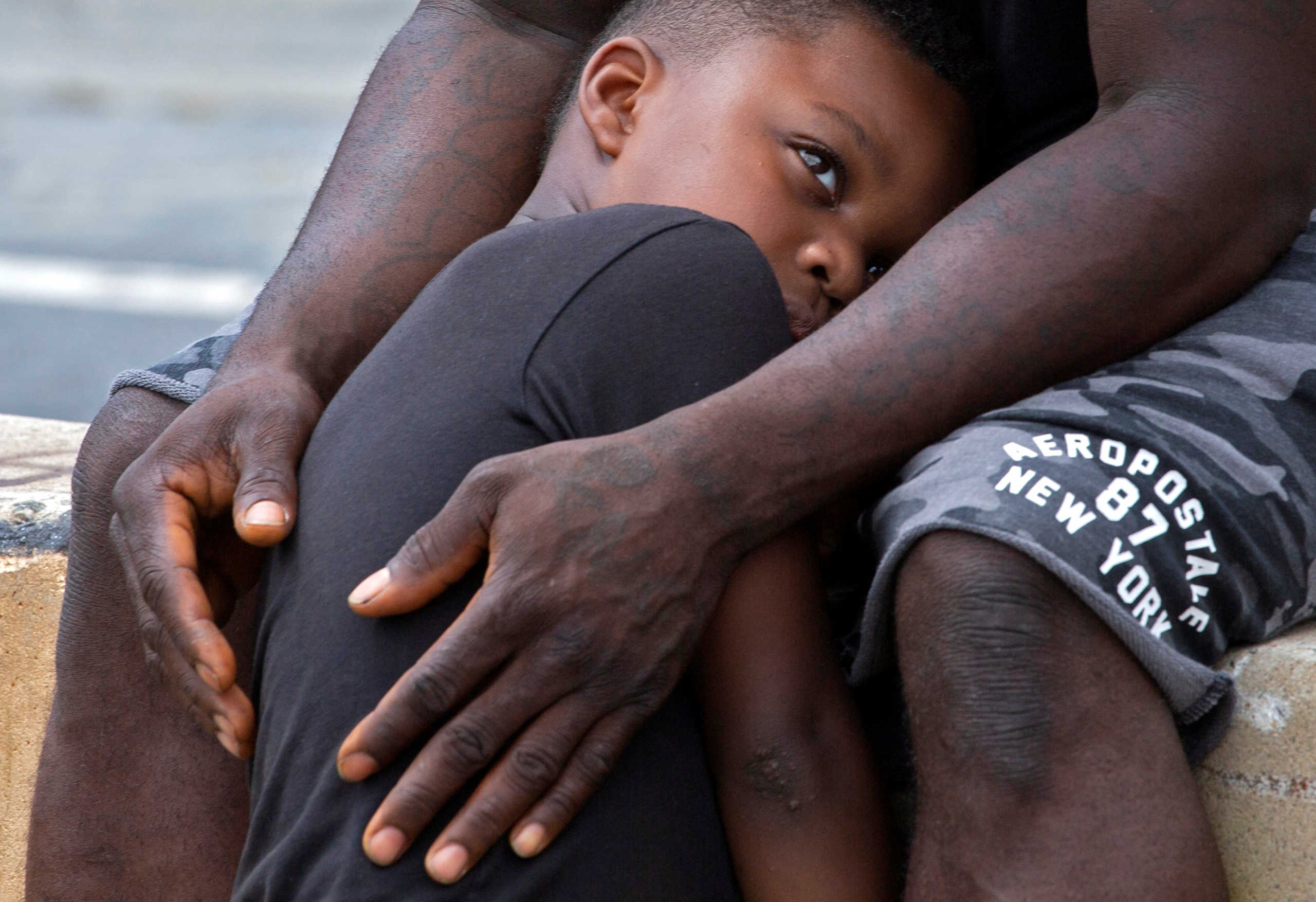 Africa Kenneth holds his son, Mandela, 5, near a statue of Confederate General Robert E. Lee in Richmond, Virginia, U.S. June 20, 2020. REUTERS