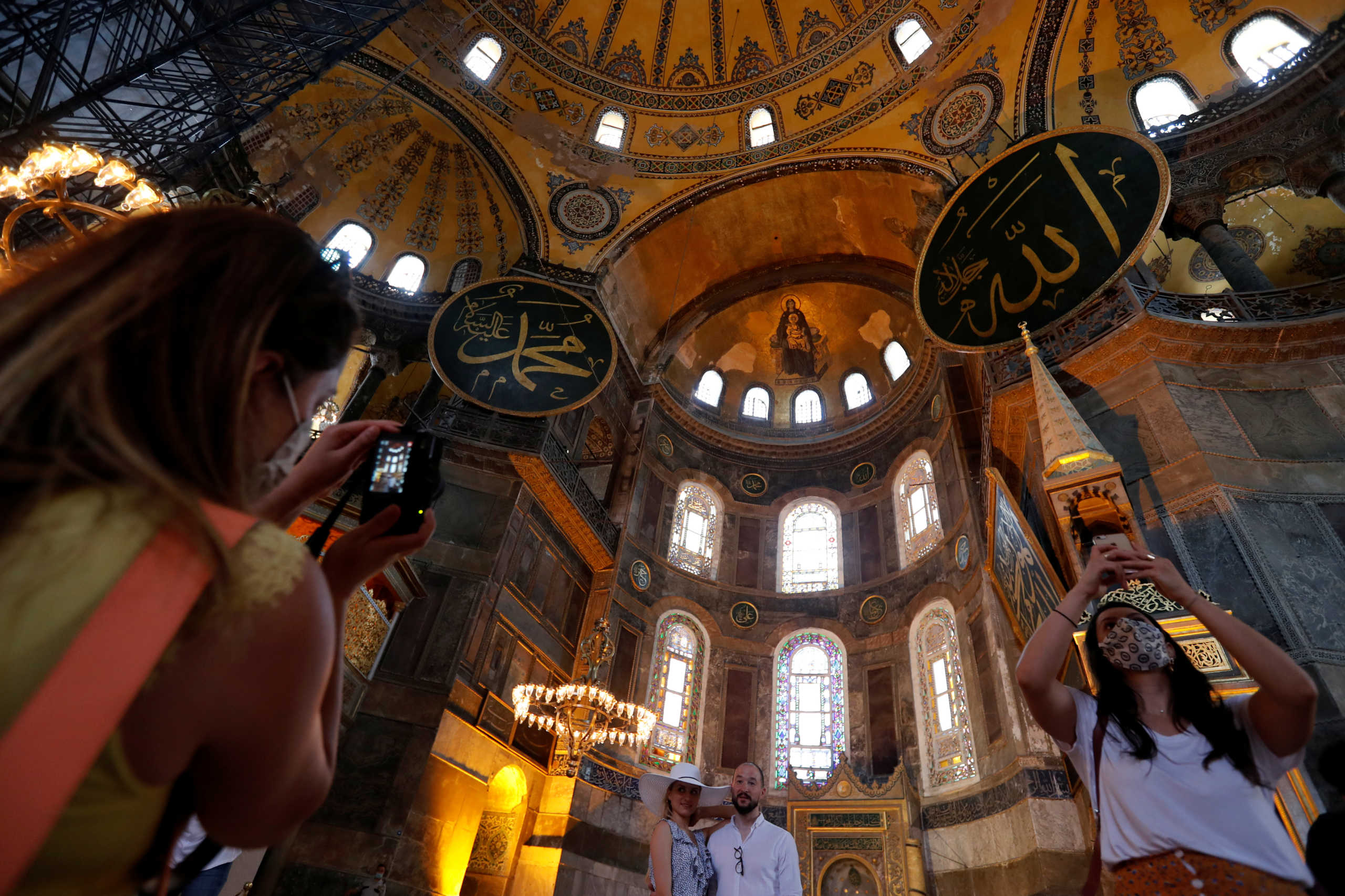 Visitors pose for a picture at Hagia Sophia or Ayasofya, a UNESCO World Heritage Site, which was a Byzantine cathedral before being converted into a mosque and currently a museum, in Istanbul, Turkey, July 10, 2020. REUTERS