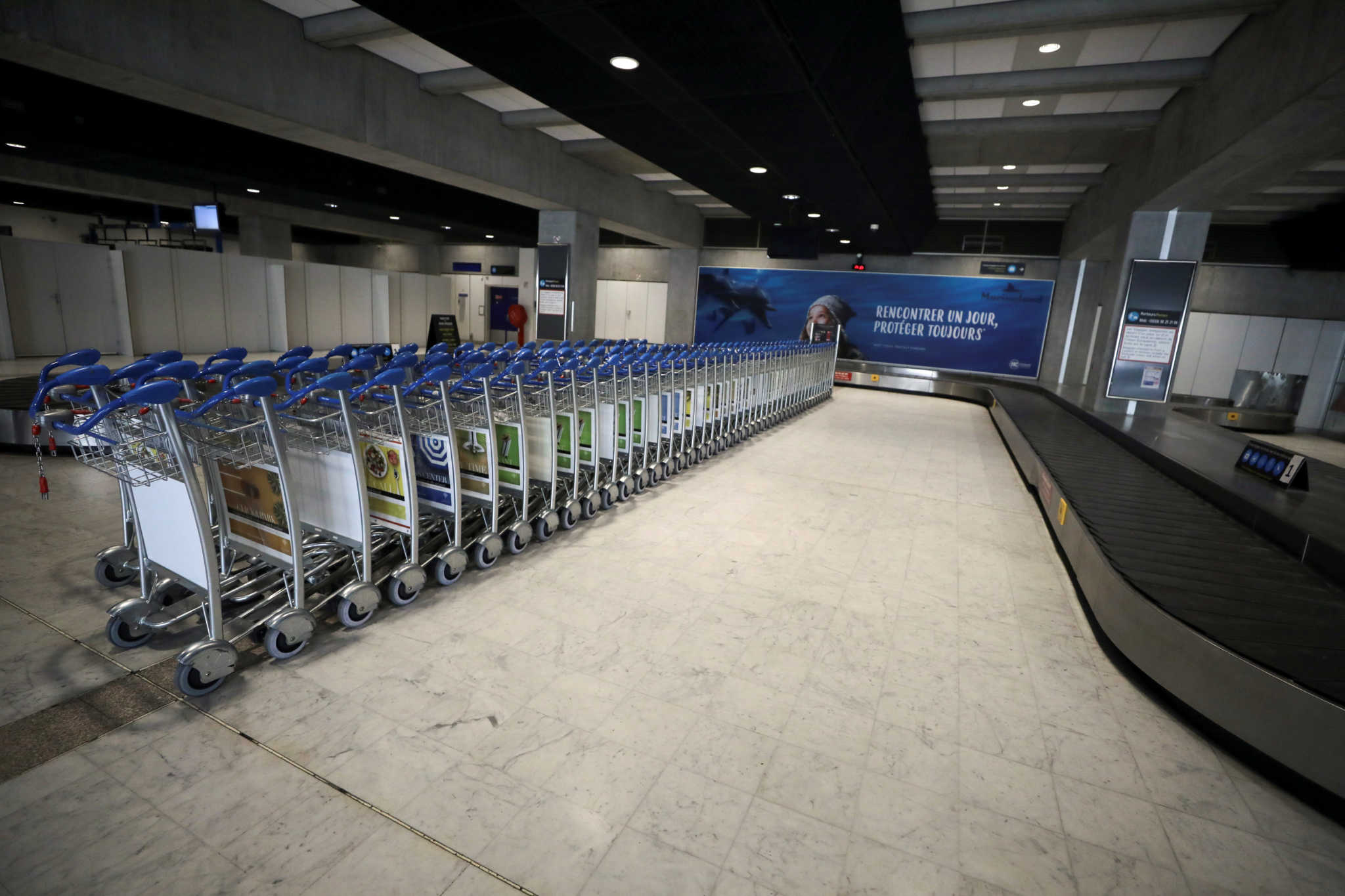 Passenger trolleys remain lined in a deserted Air France check-in desk at Nice international airport, as a lockdown is imposed to slow the rate of the coronavirus disease (COVID-19), in Nice, France April 13, 2020.  REUTERS