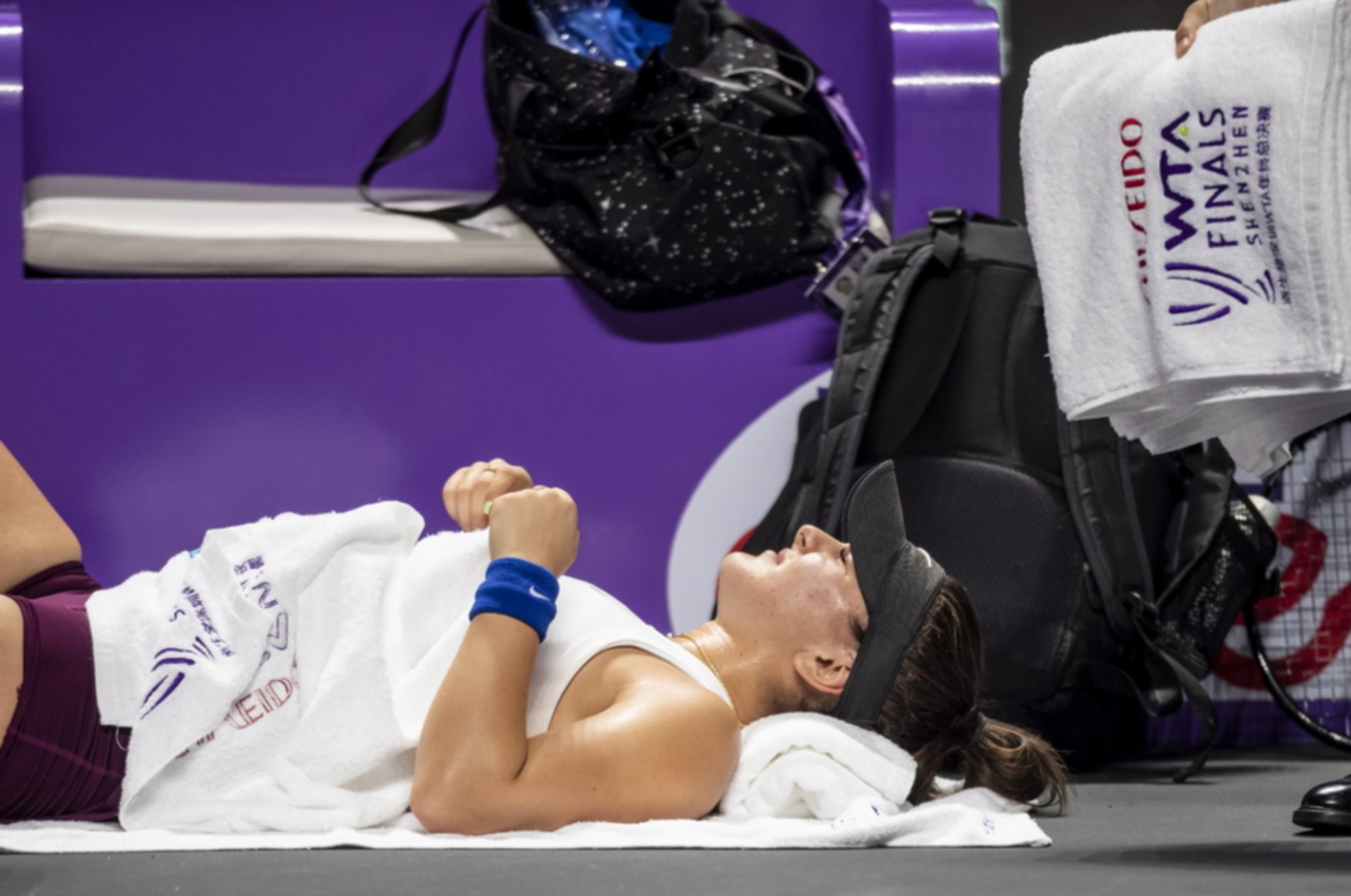 epa07959848 Bianca Andreescu of Canada rests after being injured during her match against Karolina Pliskova of Czech Republic at the WTA Finals 2019 tennis tournament in Shenzhen, China, 30 October 2019.  EPA