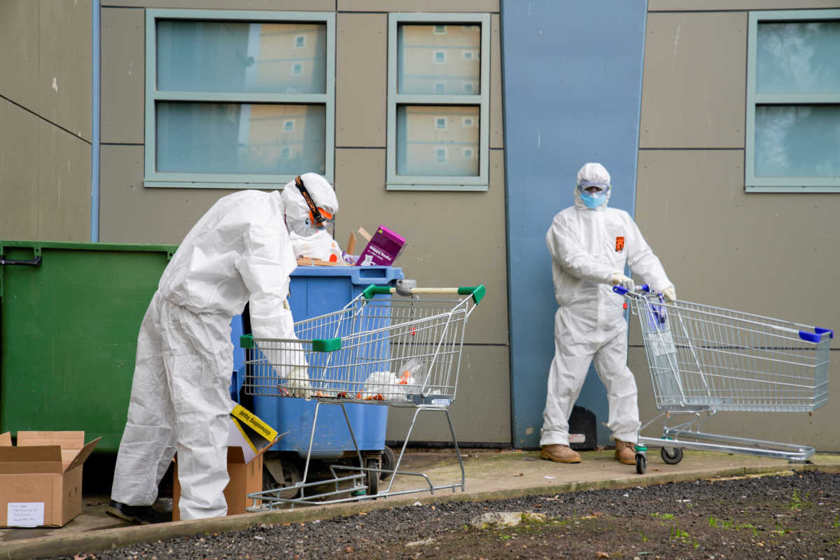 Response personnel dispose of rubbish outside a public housing tower, reopened the previous night after being locked down in response to an outbreak of the coronavirus disease (COVID-19), in Melbourne, Australia, July 10, 2020. REUTERS
