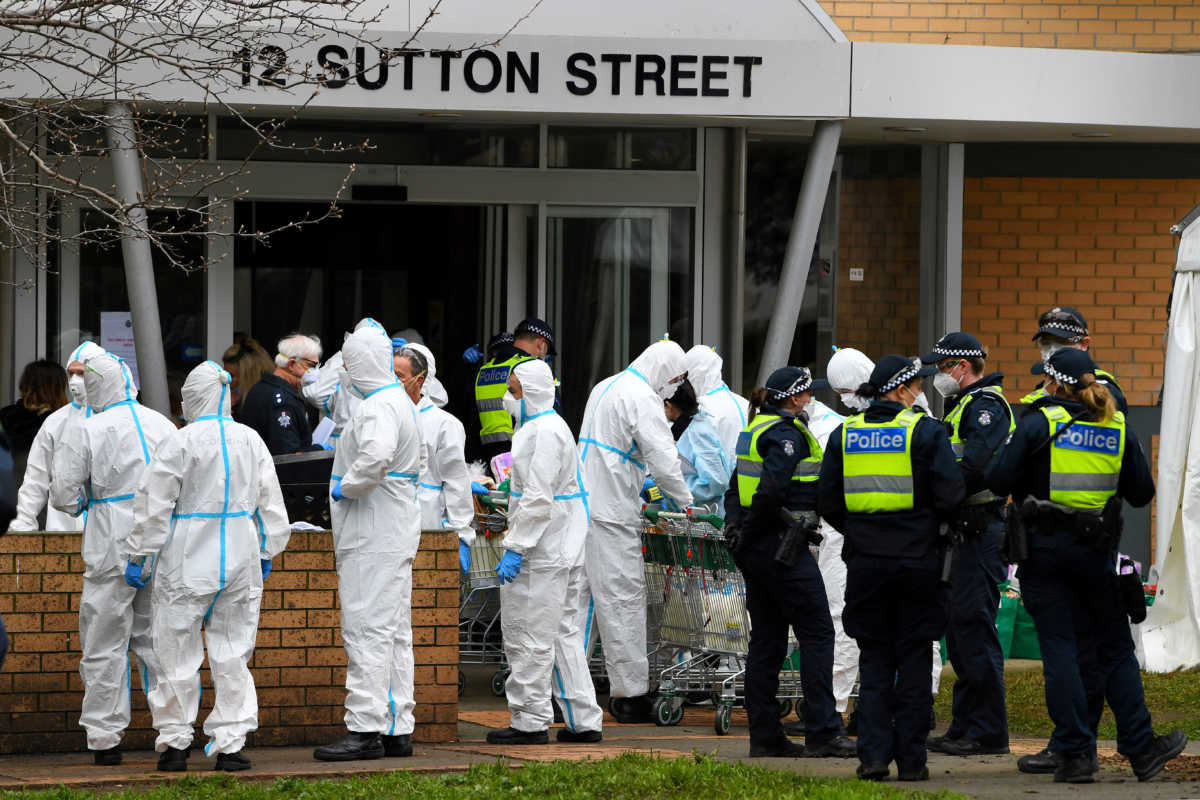 Firefighters dressed in personal protective equipment prepare to distribute food throughout a public housing tower, locked down in response to an outbreak of the coronavirus disease (COVID-19), in Melbourne, Australia, July 7, 2020.  AAP Image