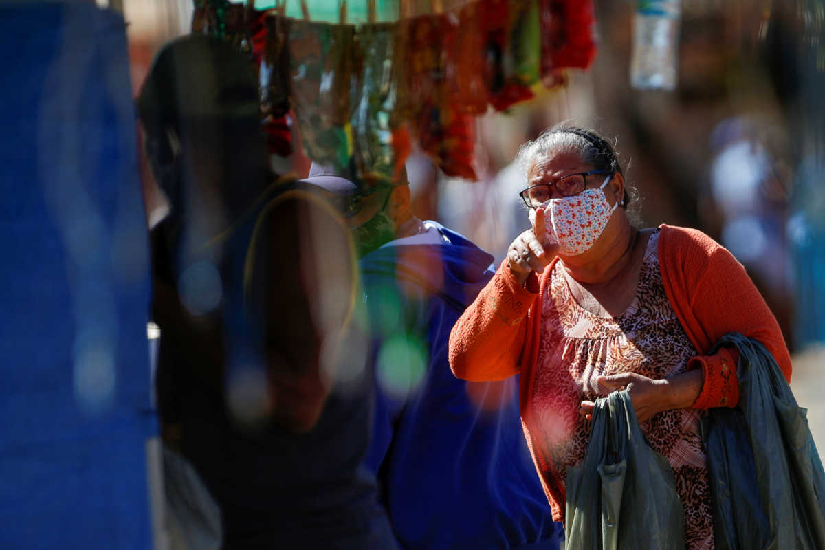 A woman wears a protective face mask as she gestures on a street in the Ceilandia neighborhood, amid the coronavirus disease (COVID-19) outbreak, in Brasilia, Brazil July 7, 2020. Picture taken July 7, 2020. REUTERS