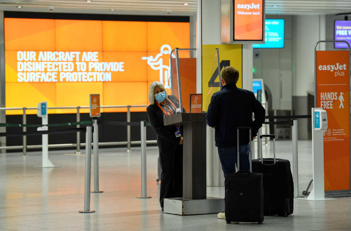 A passenger checks in at an Easy Jet checking area at Gatwick Airport, as travel restrictions are eased following the coronavirus disease (COVID-19) outbreak, in Gatwick, Britain July 10, 2020. REUTERS