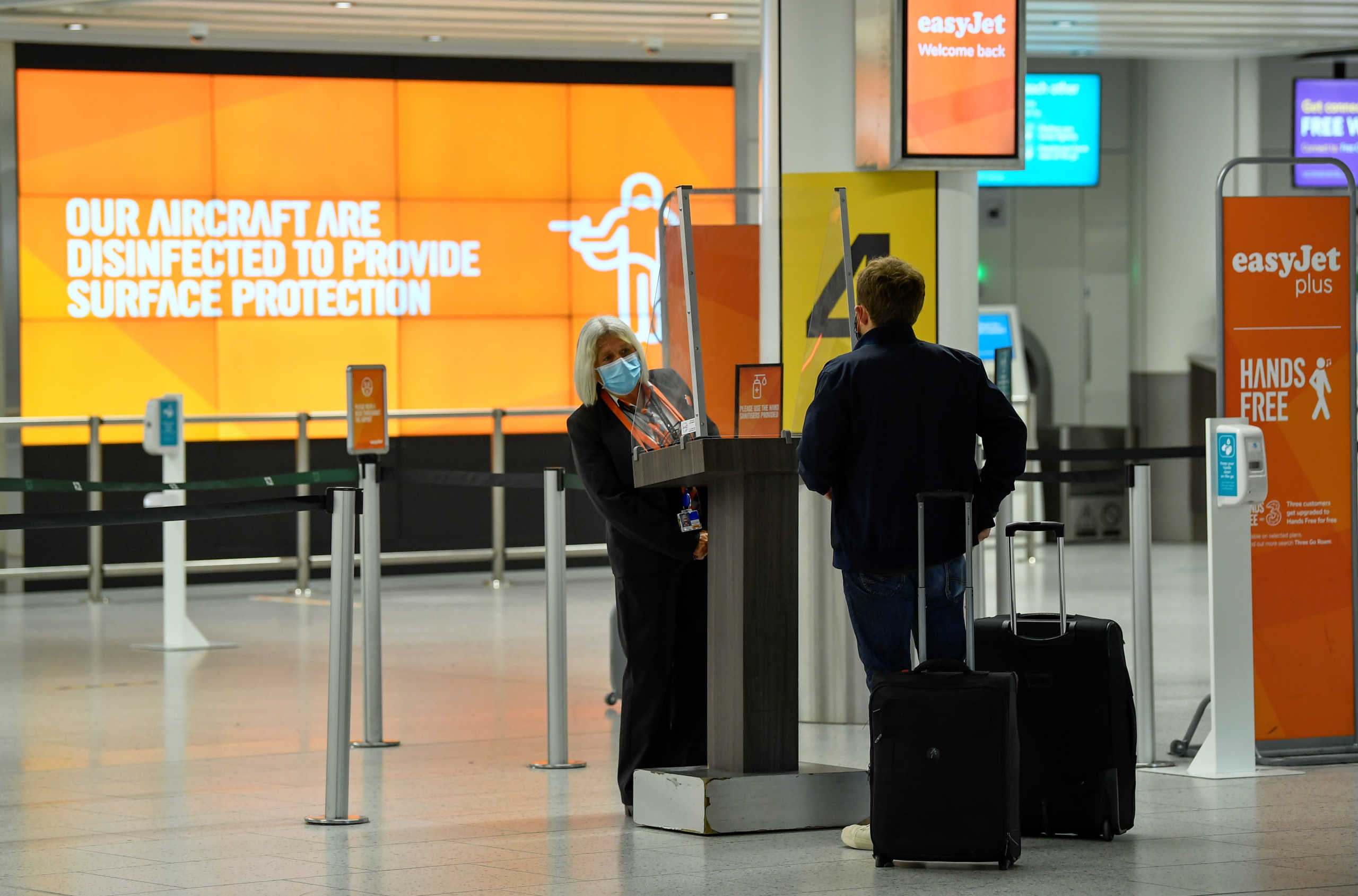 A passenger checks in at an Easy Jet checking area at Gatwick Airport, as travel restrictions are eased following the coronavirus disease (COVID-19) outbreak, in Gatwick, Britain July 10, 2020. REUTERS