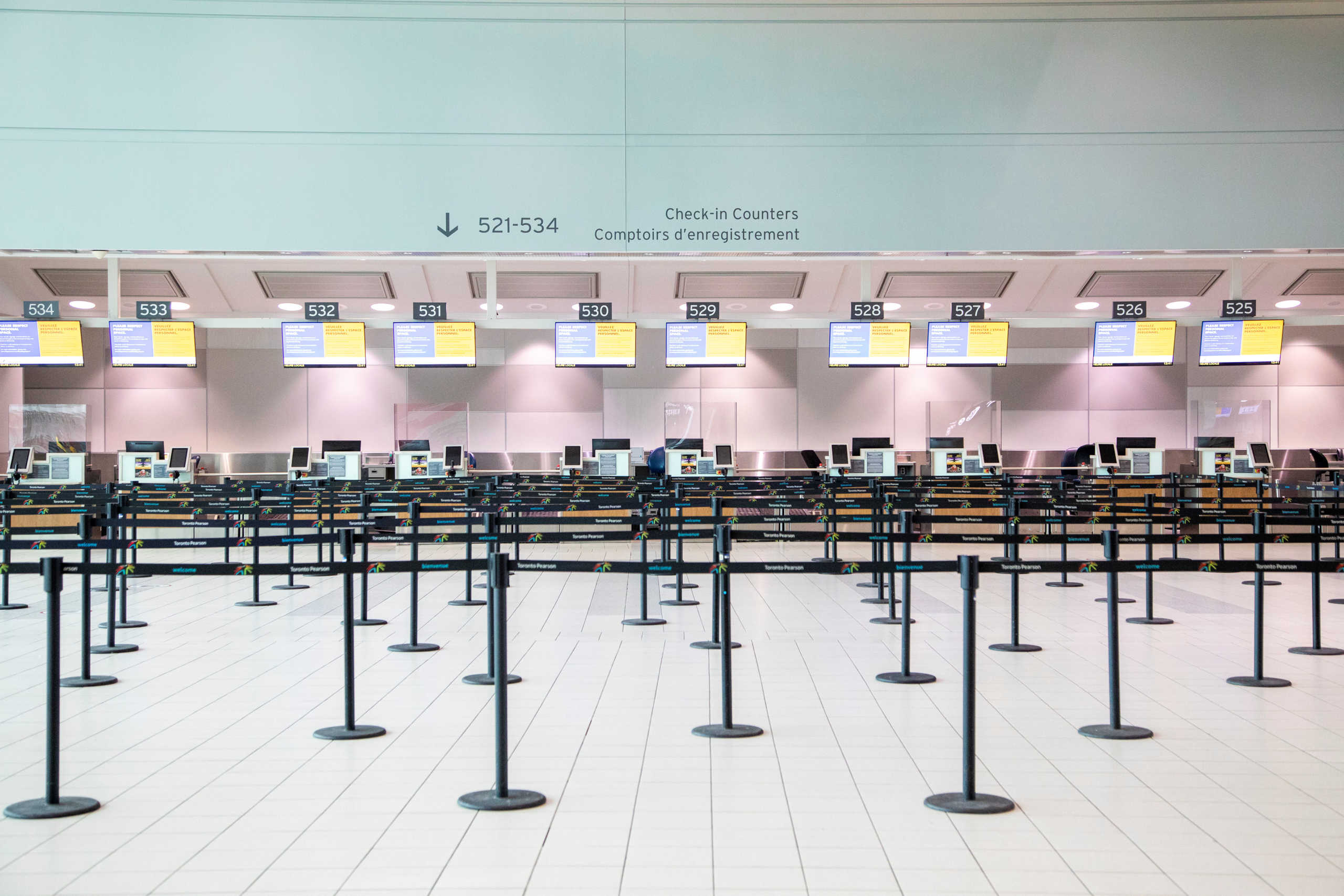An empty check-in counter is pictured as a "Healthy Airport" initiative is launched for travel, taking into account social distancing protocols to slow the spread of the coronavirus disease (COVID-19) at Toronto Pearson International Airport in Toronto, Ontario, Canada June 23, 2020.  REUTERS