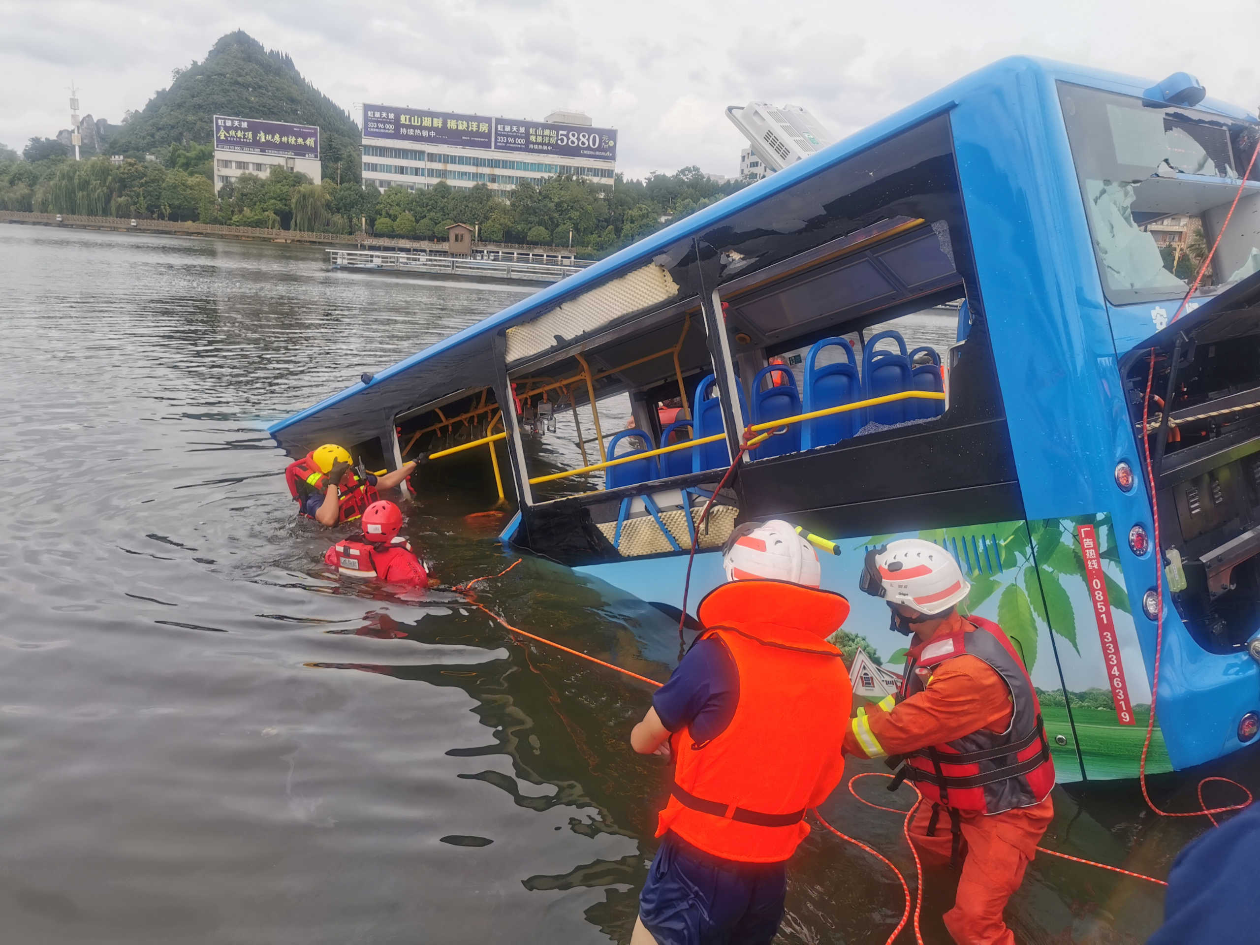 Rescue workers are seen at the site where a bus carrying students plunged into a reservoir, in Anshun, Guizhou province, China July 7, 2020. China Daily via REUTERS  ATTENTION EDITORS - THIS IMAGE WAS PROVIDED BY A THIRD PARTY. CHINA OUT.